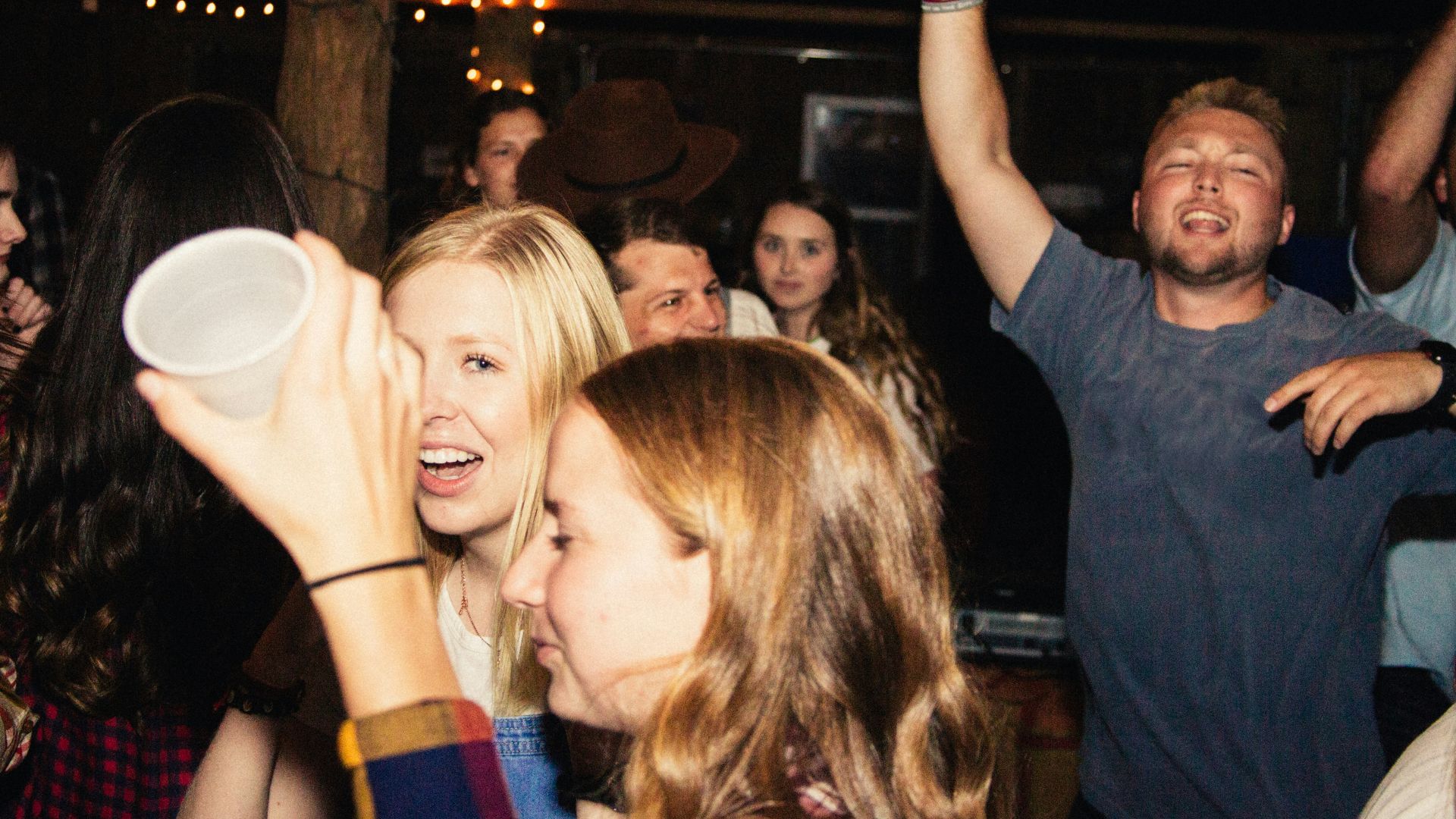 man in black crew neck t-shirt holding white ceramic mug