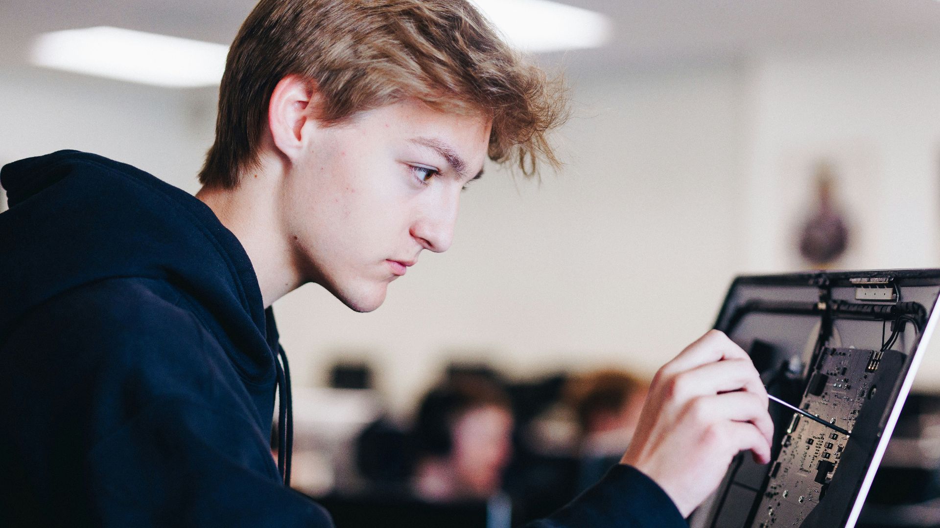 a young man working on a laptop computer