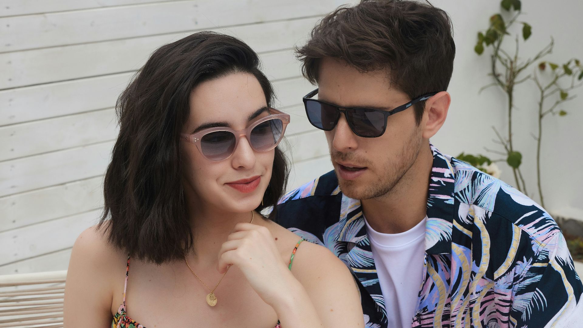 A man and a woman sitting on a bench