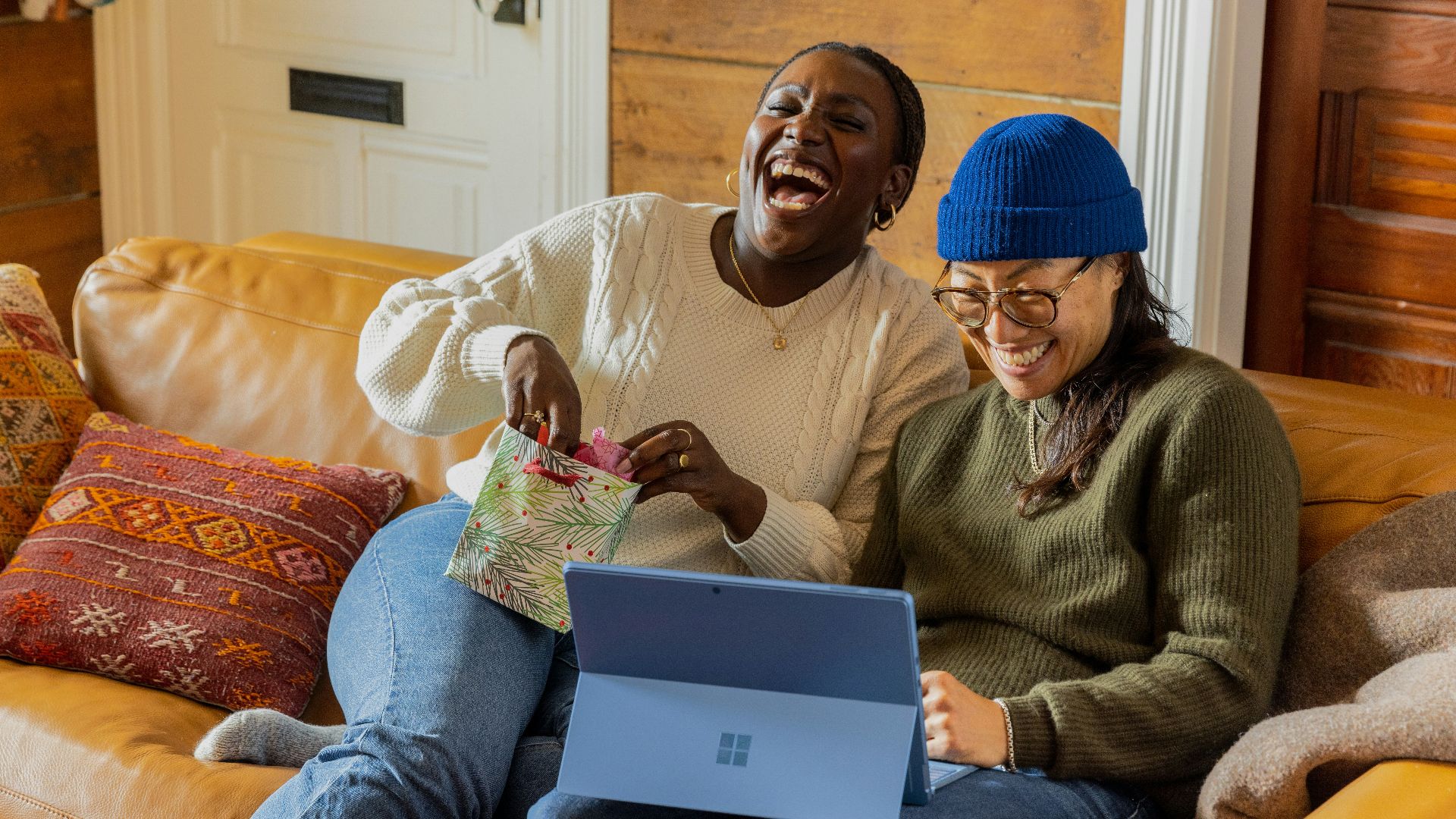 a person sitting on a couch with a laptop