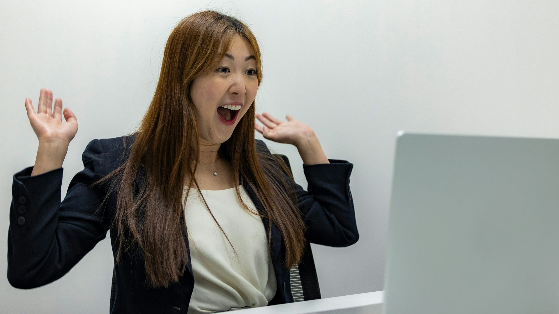 a woman sitting in front of a laptop computer