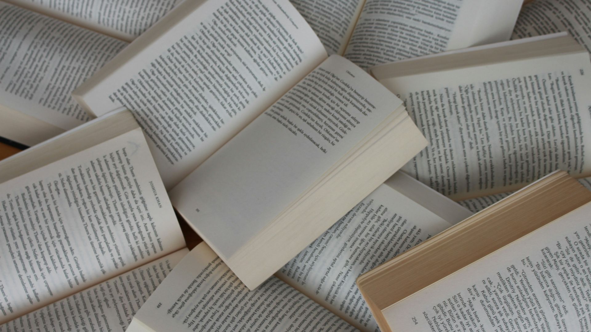 white and brown book on brown woven surface