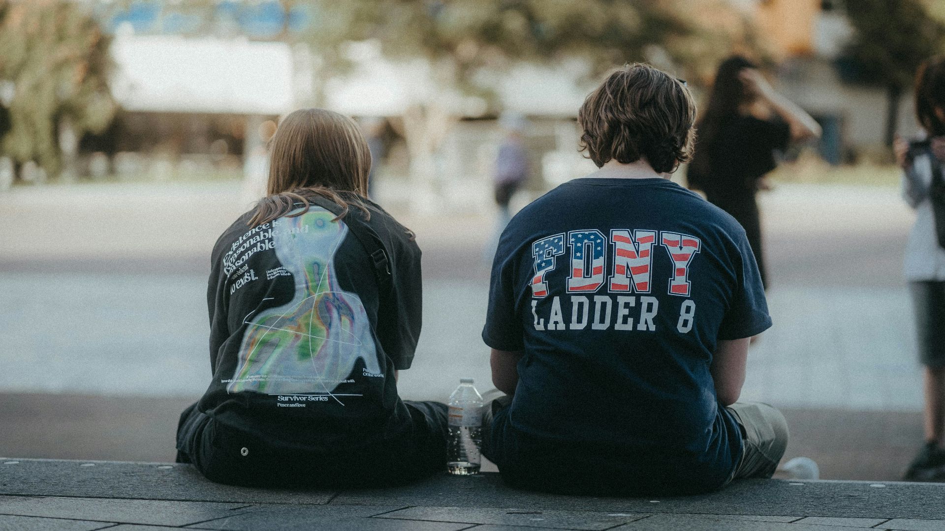 a couple of kids sitting on the ground next to each other