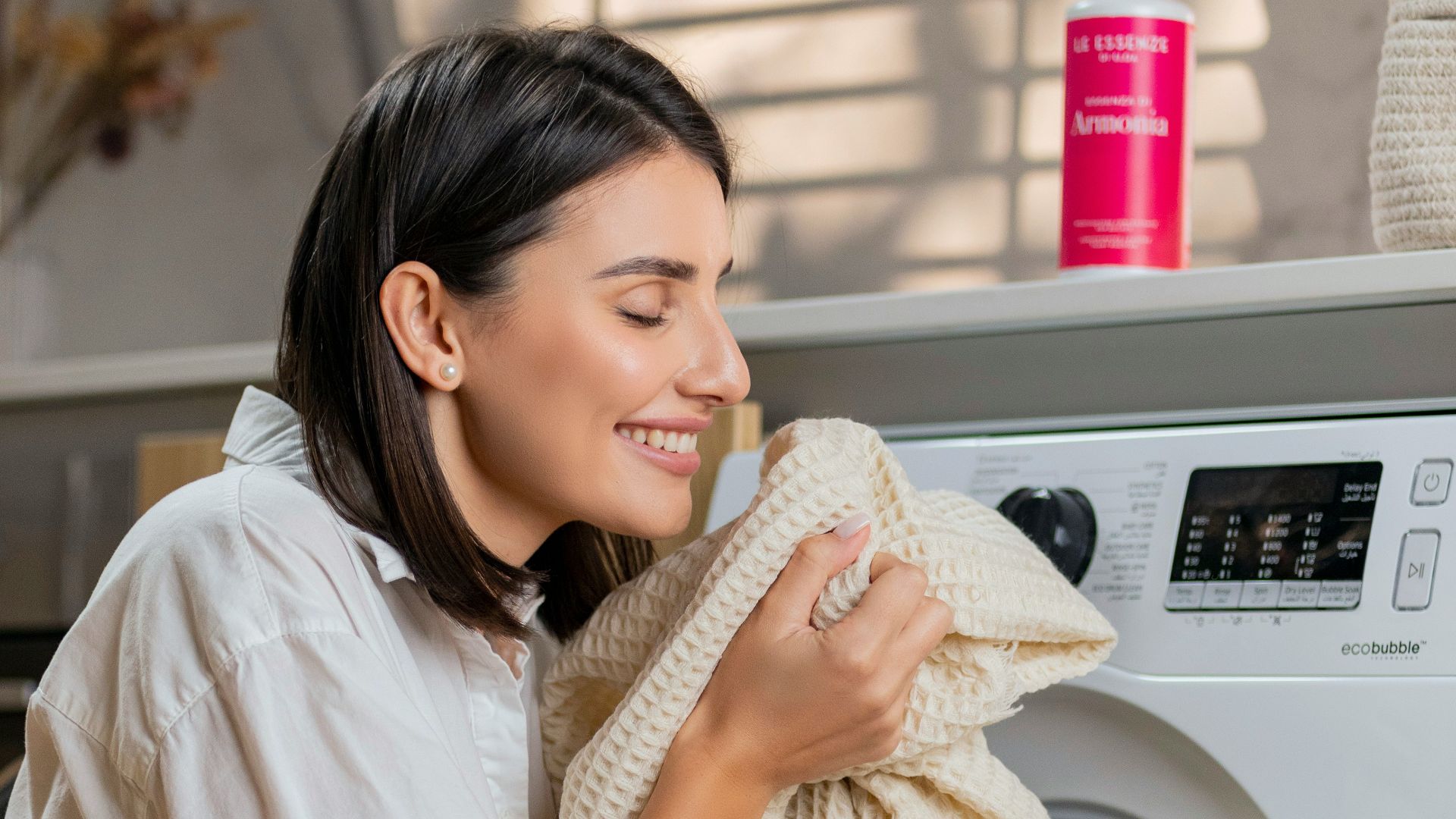 a woman is sitting on a washing machine