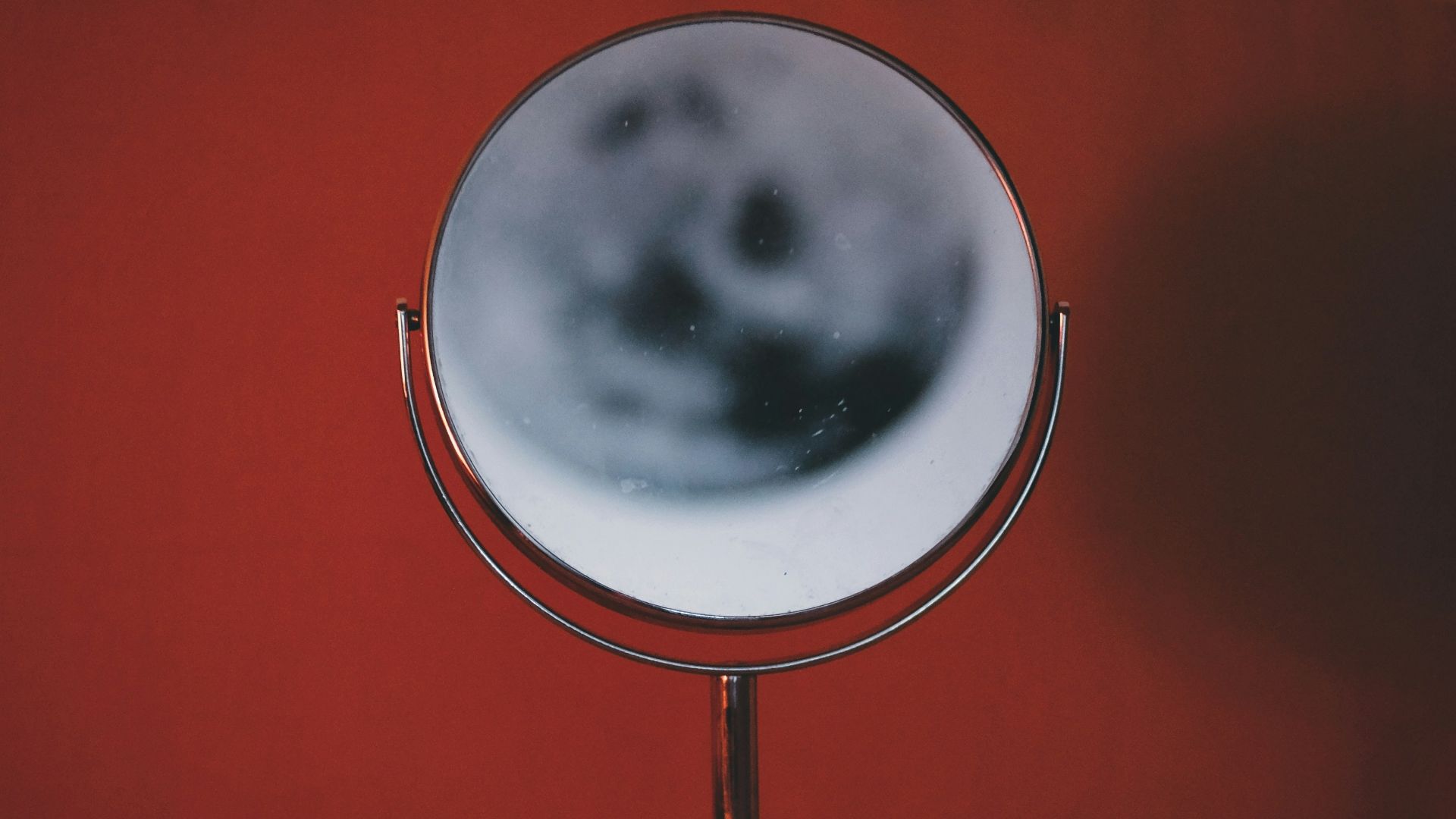 a mirror on a stand on a table