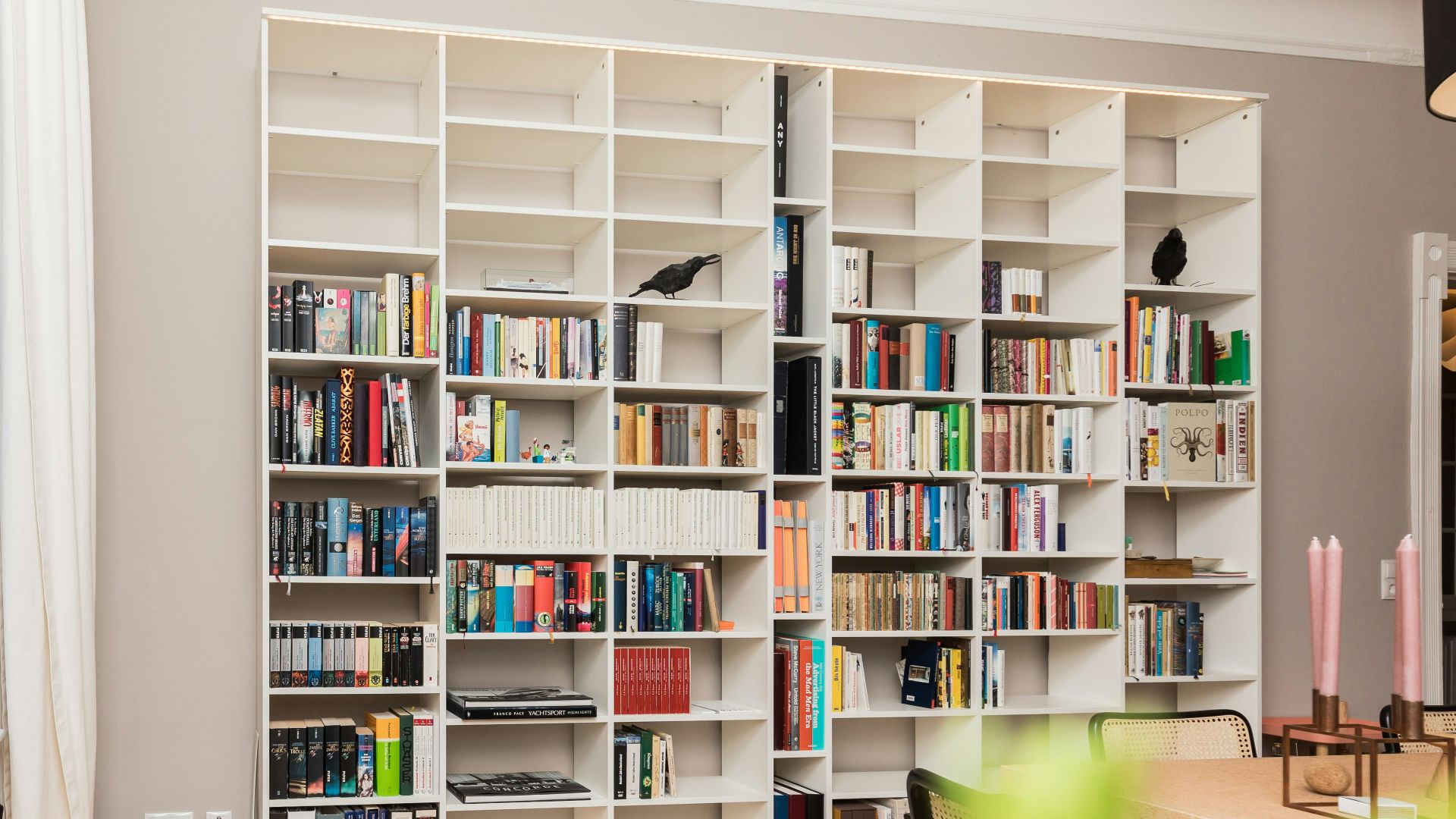 white wooden book shelves on brown wooden parquet floor