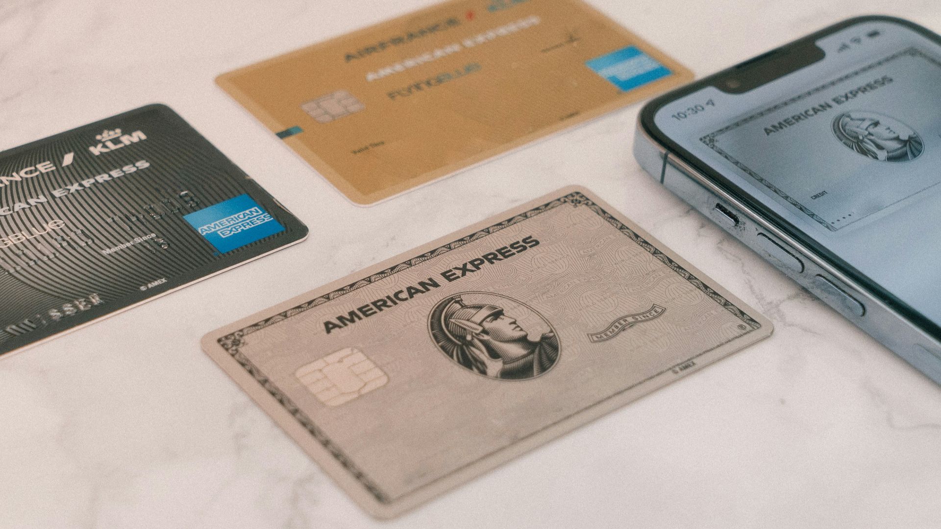 a group of credit cards sitting next to a cell phone