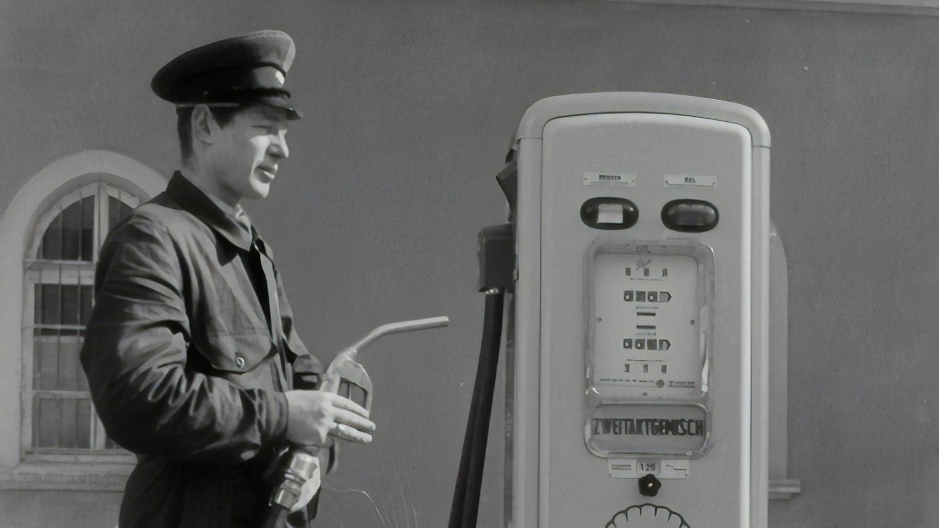 man in black coat holding microphone