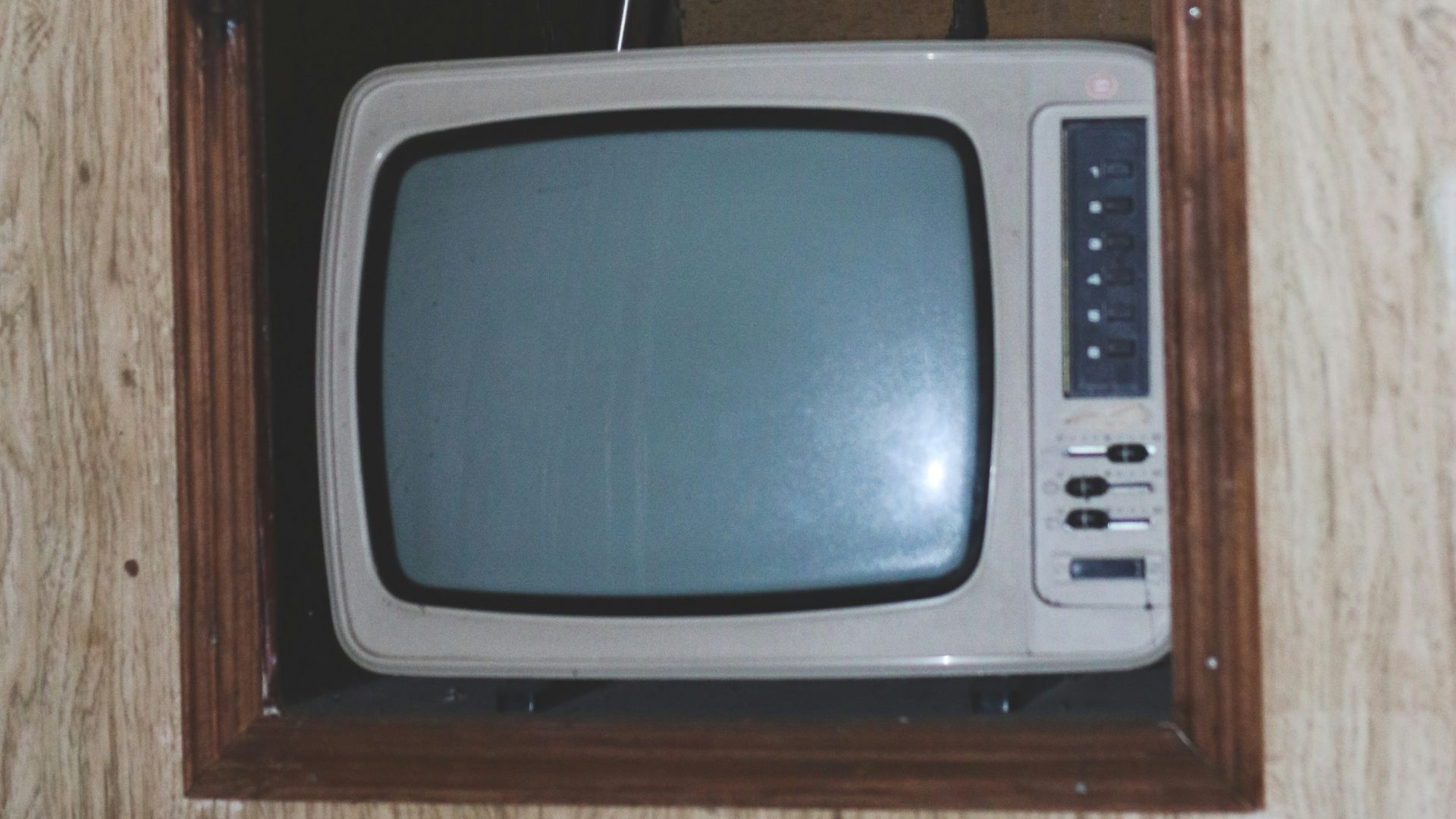 gray crt tv on brown wooden tv hutch