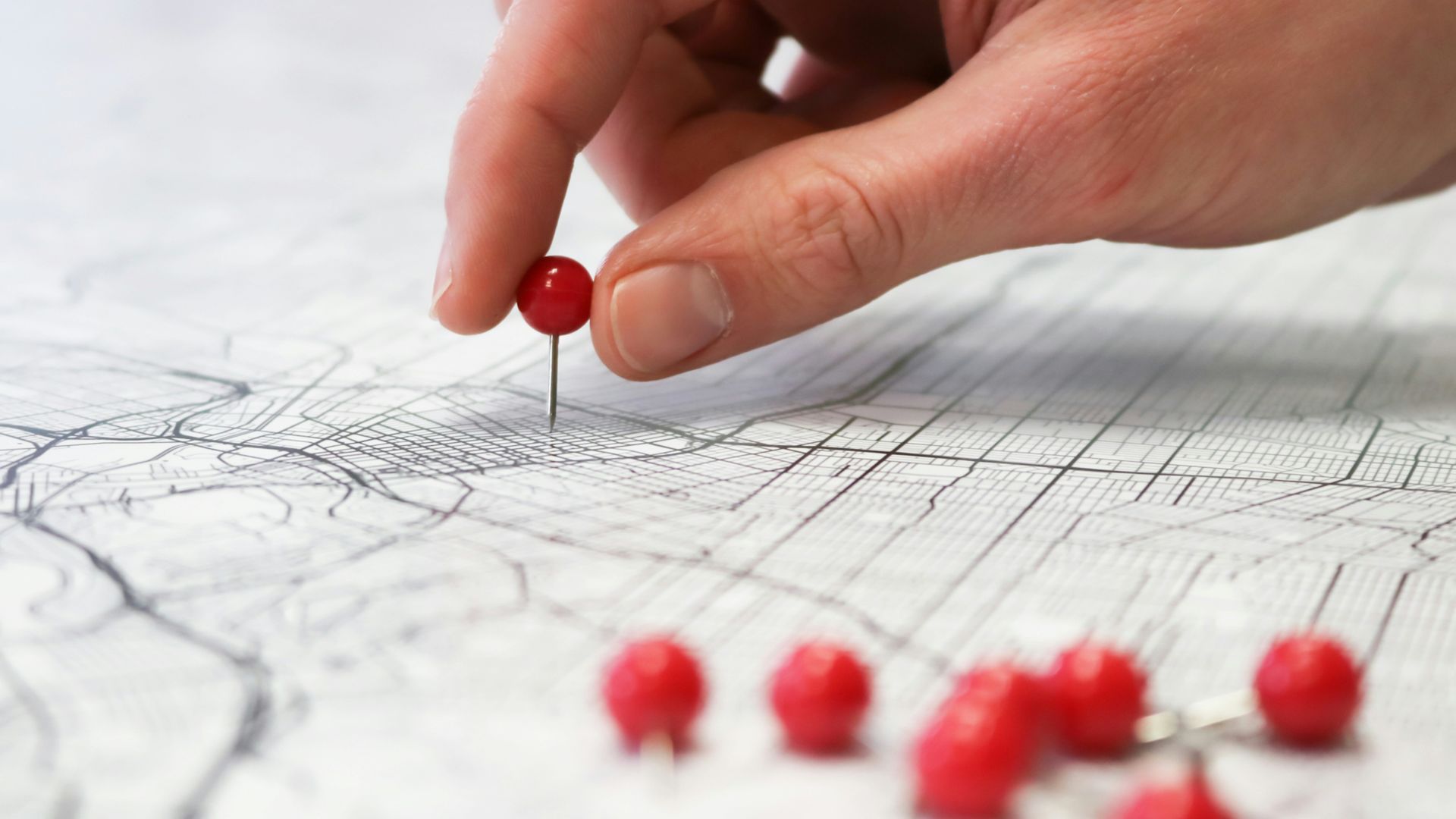 person holding red round medication pill