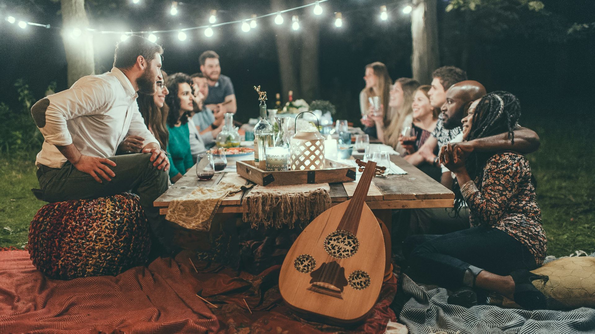 people sitting on chair in front of table with candles and candles