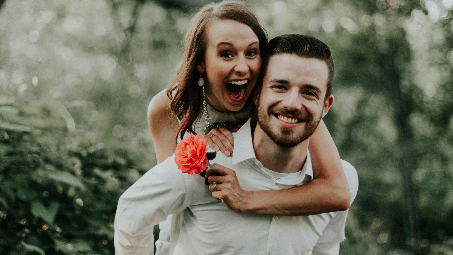 woman riding on back of man