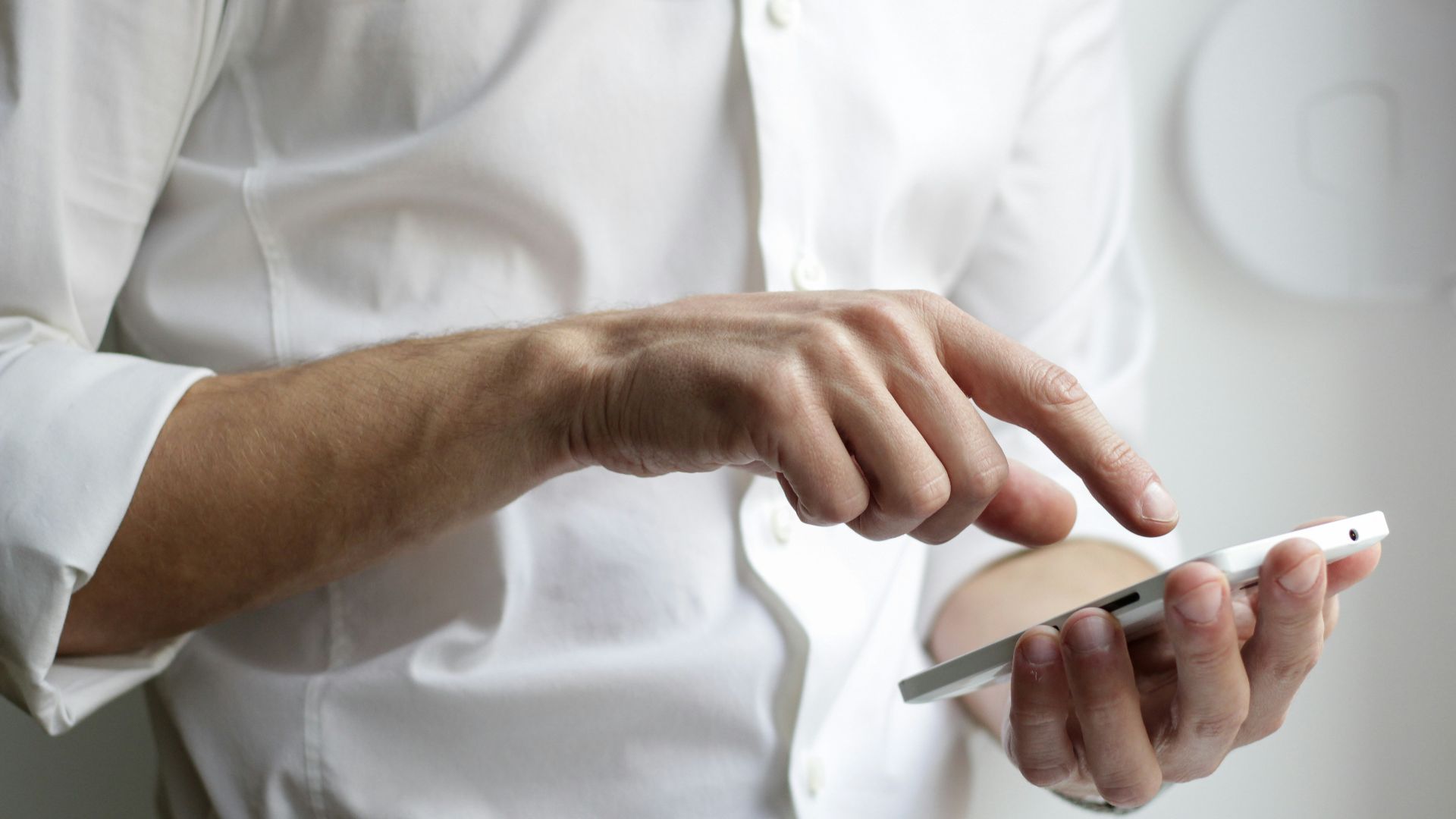person holding white Android smartphone in white shirt