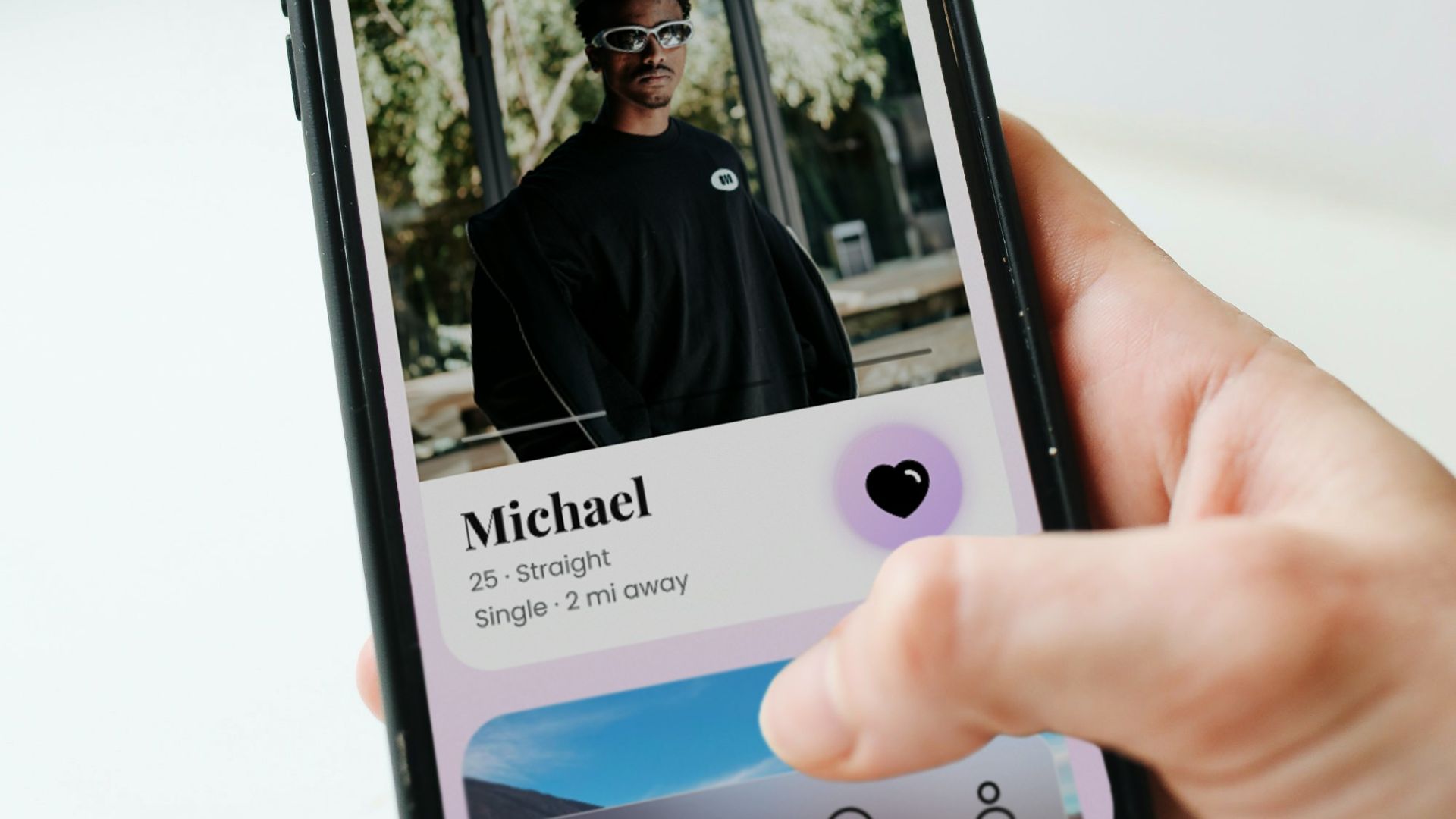 a person holding a cell phone with a picture of a man on it