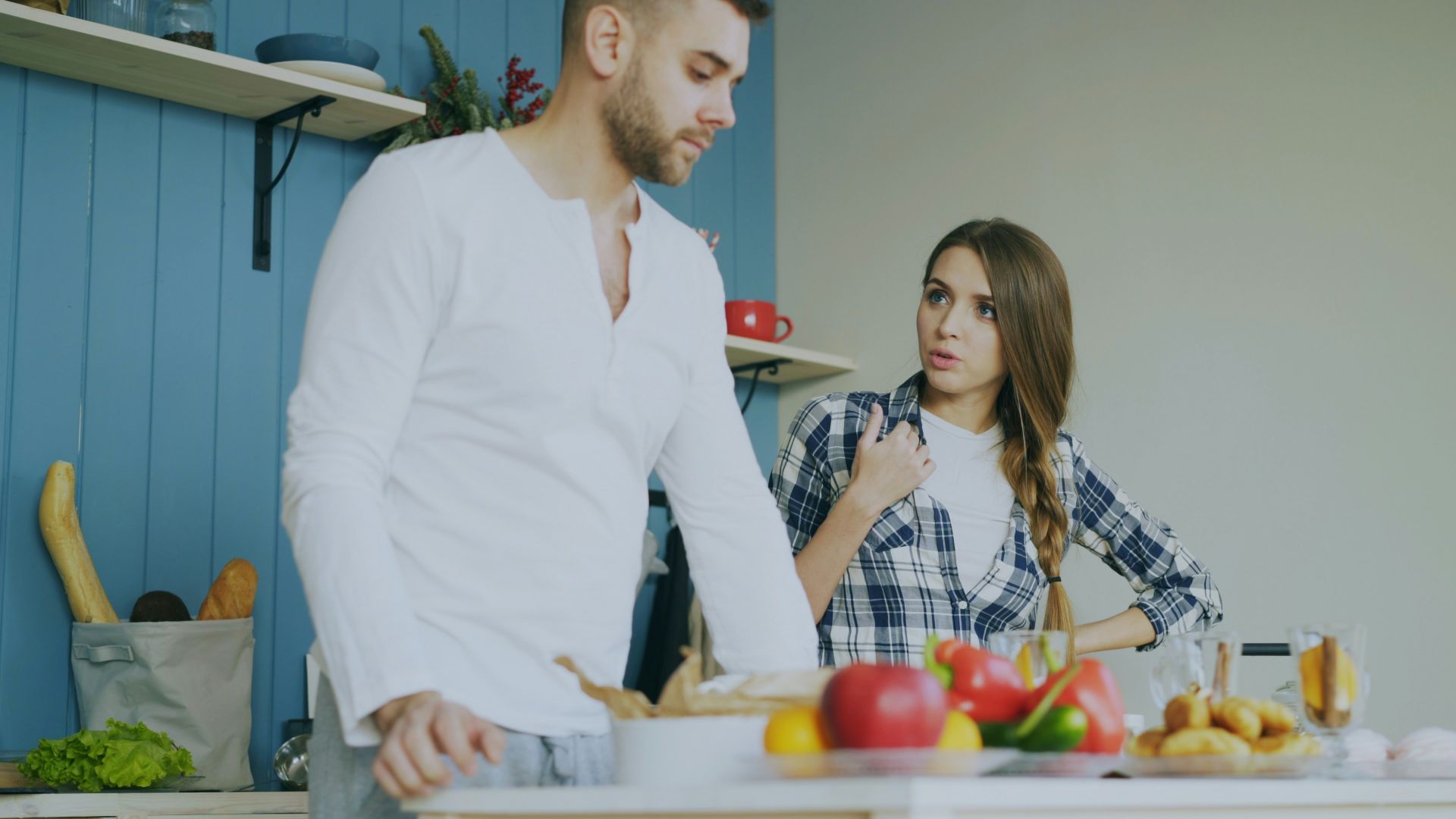 Couple arguing in a kitchen