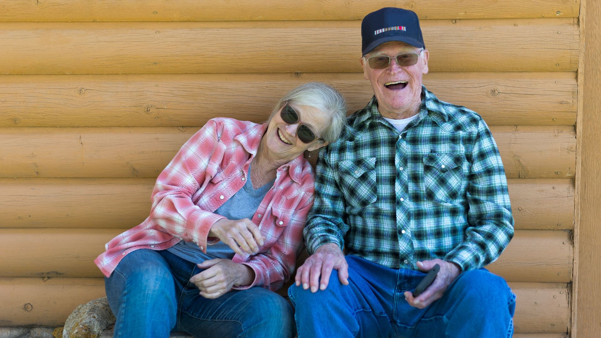 Elderly couple sitting together outdoors