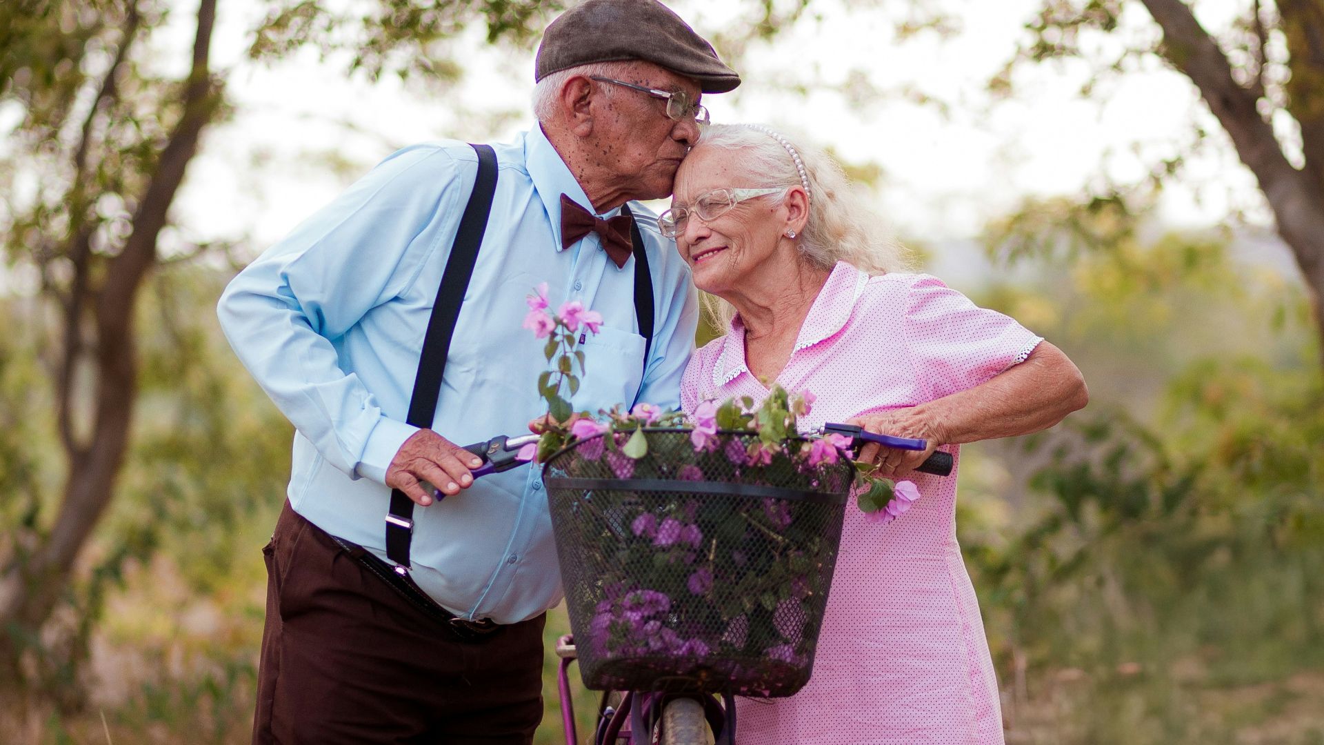 A man and a woman standing next to a bike