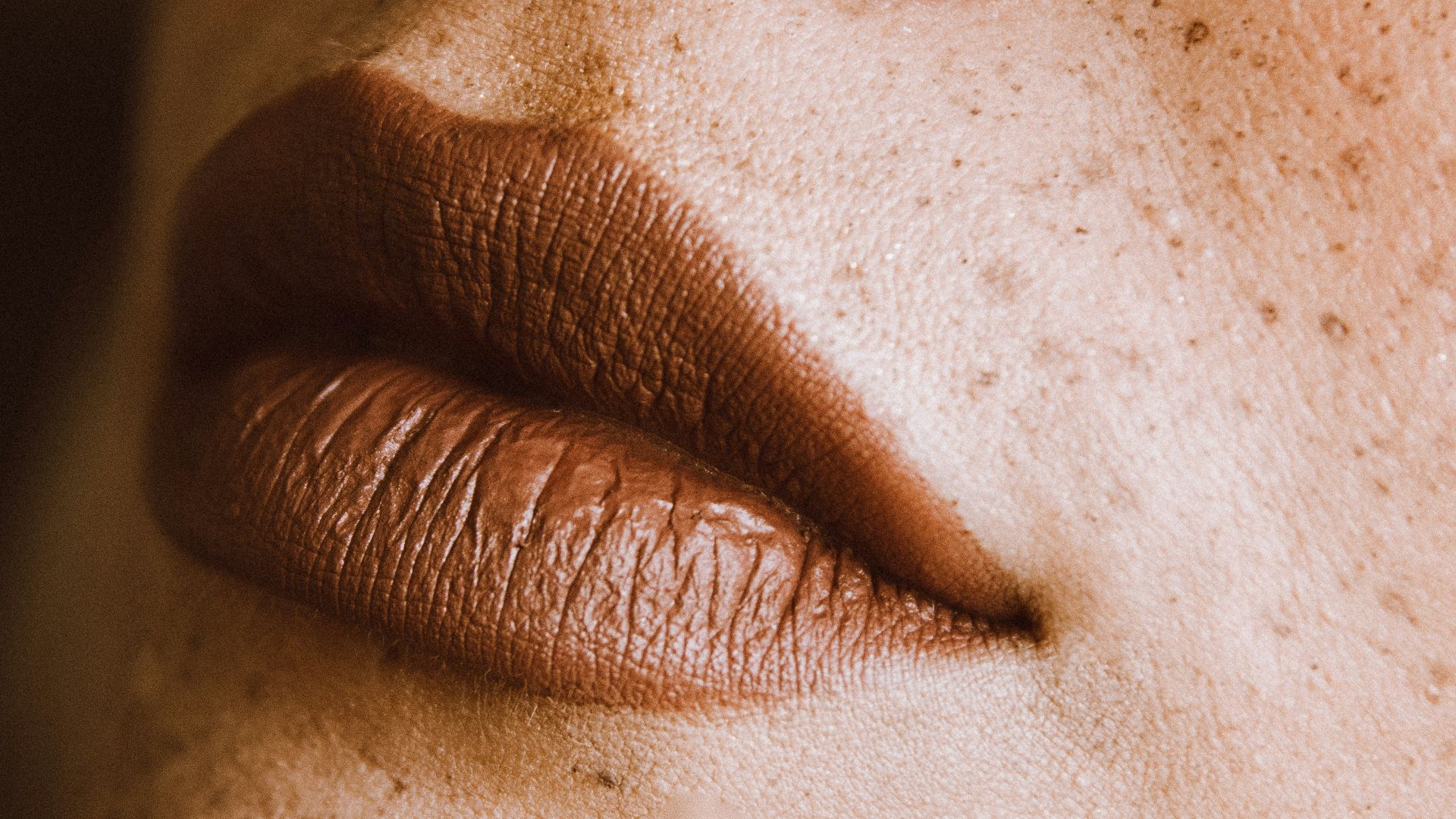 a close up of a woman's face with freckles
