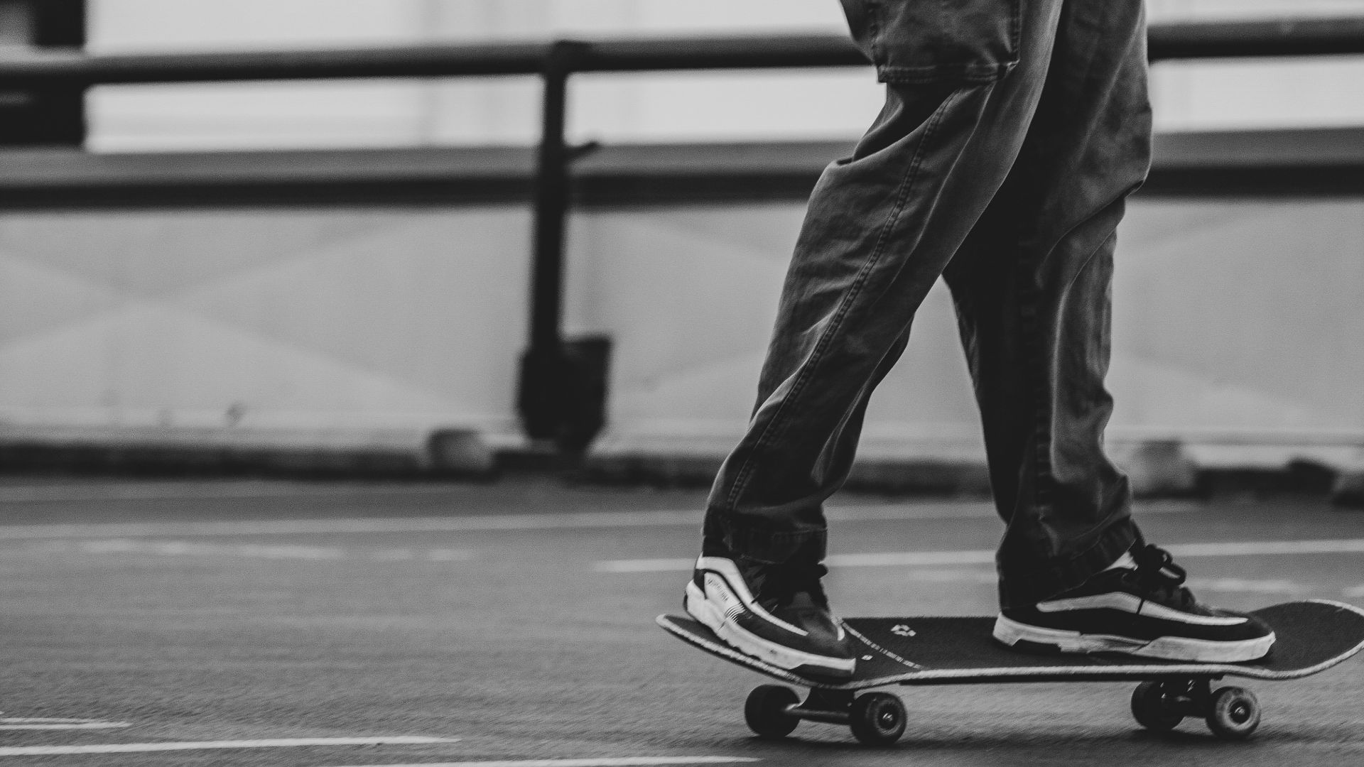 grayscale photo of man in black shirt and pants standing on field