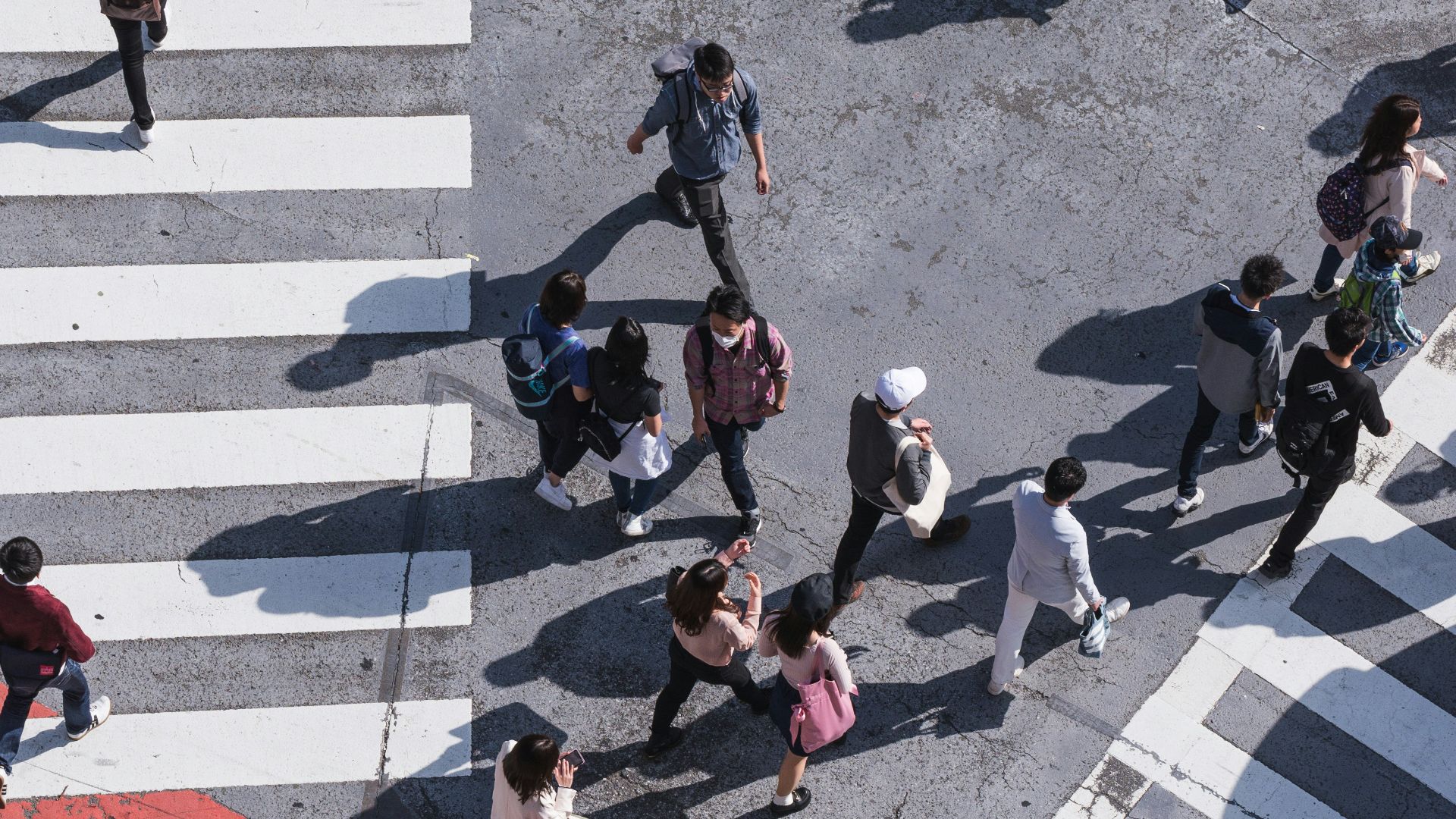 aerial photography of people crossing pedestrian lane