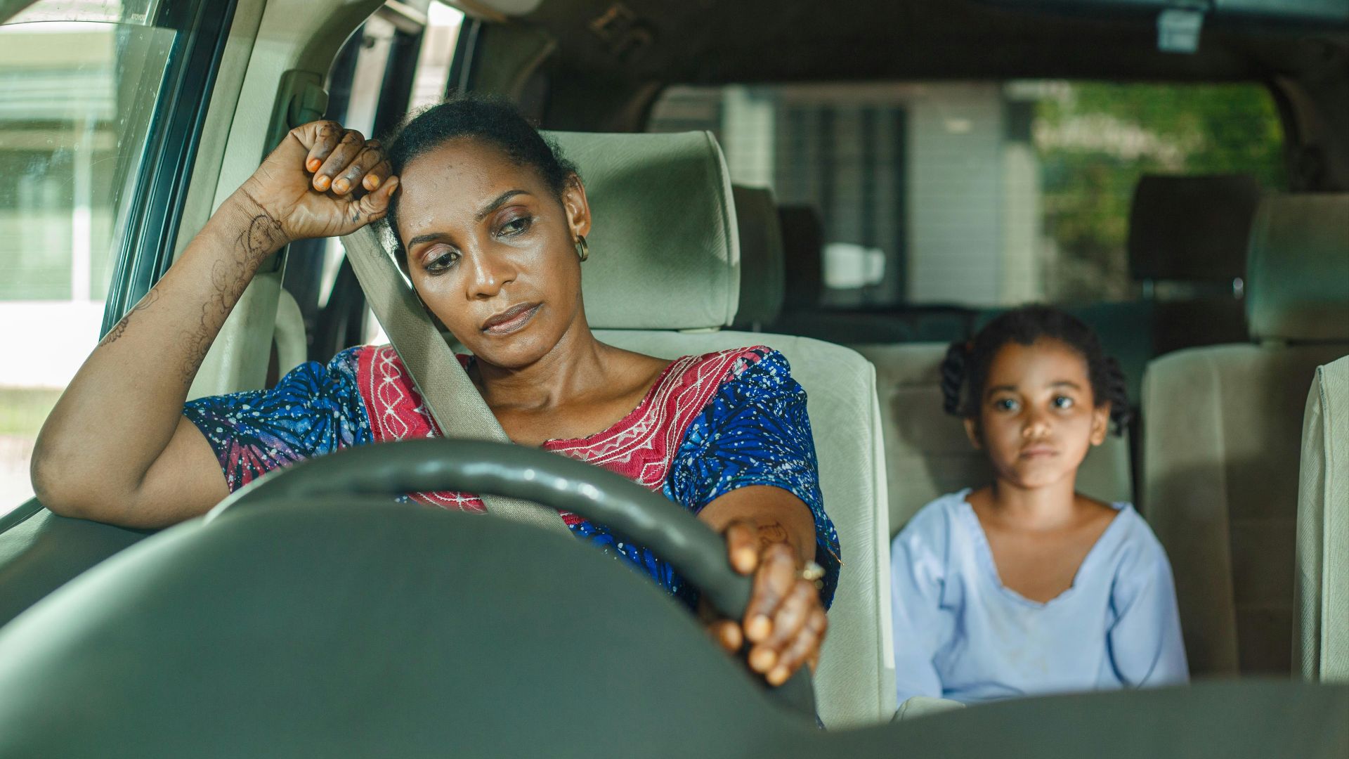a woman and a child sitting in a car