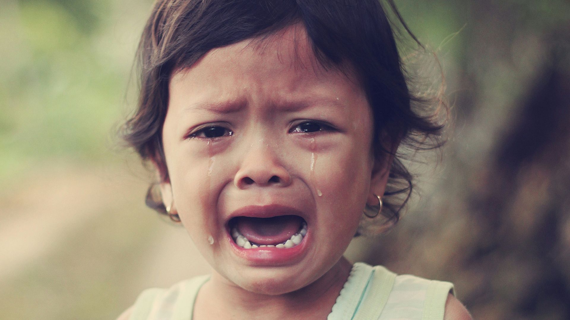 selective focus photography of girl crying