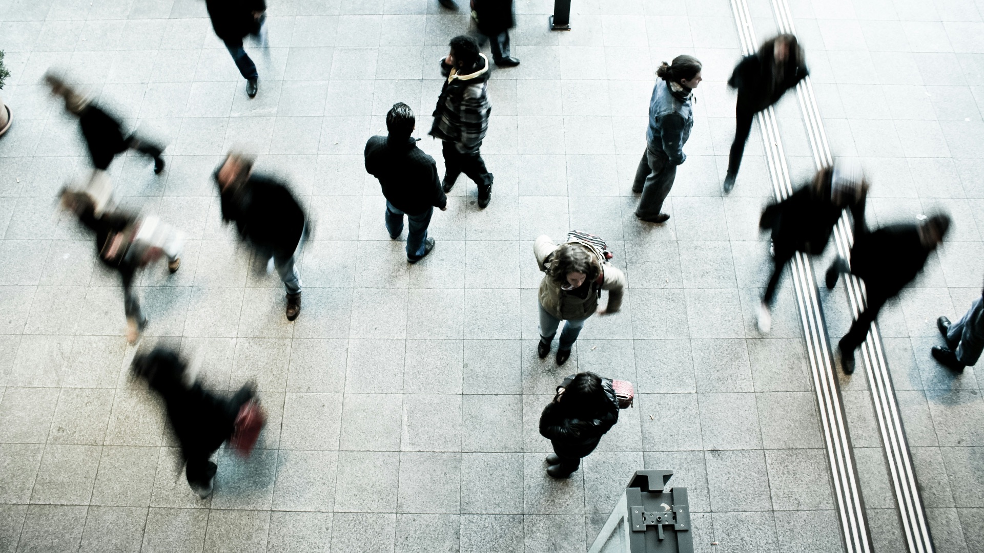 people walking on grey concrete floor during daytime