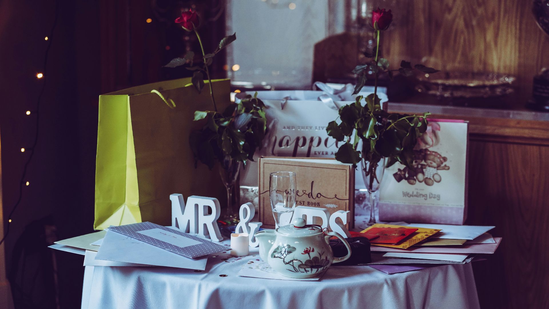 two red roses and mr. & mrs. free-standing letters on top of table