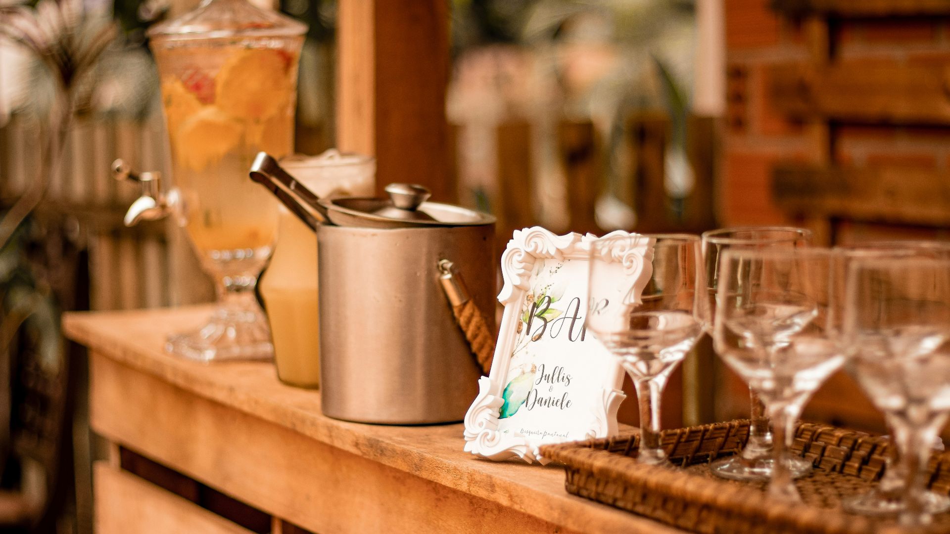 a wooden table topped with glasses and a pot