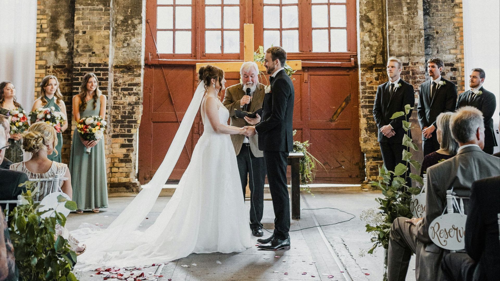 A bride and groom standing in front of a chandelier