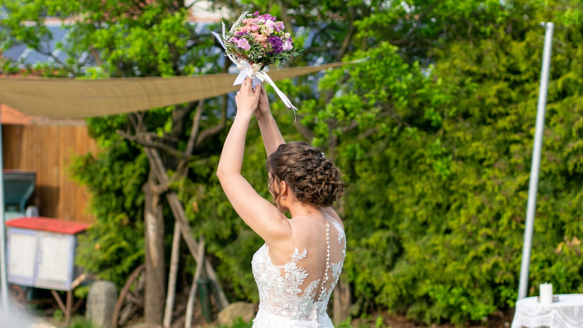a woman in a wedding dress holding a bouquet of flowers