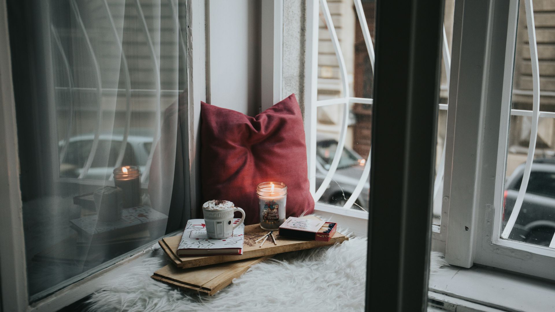 photo of gel candle on board beside pillow