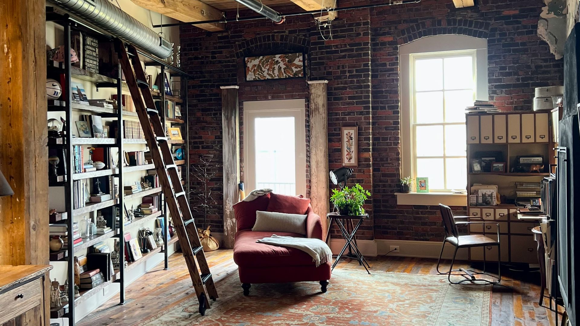 a room with a ladder and bookshelves