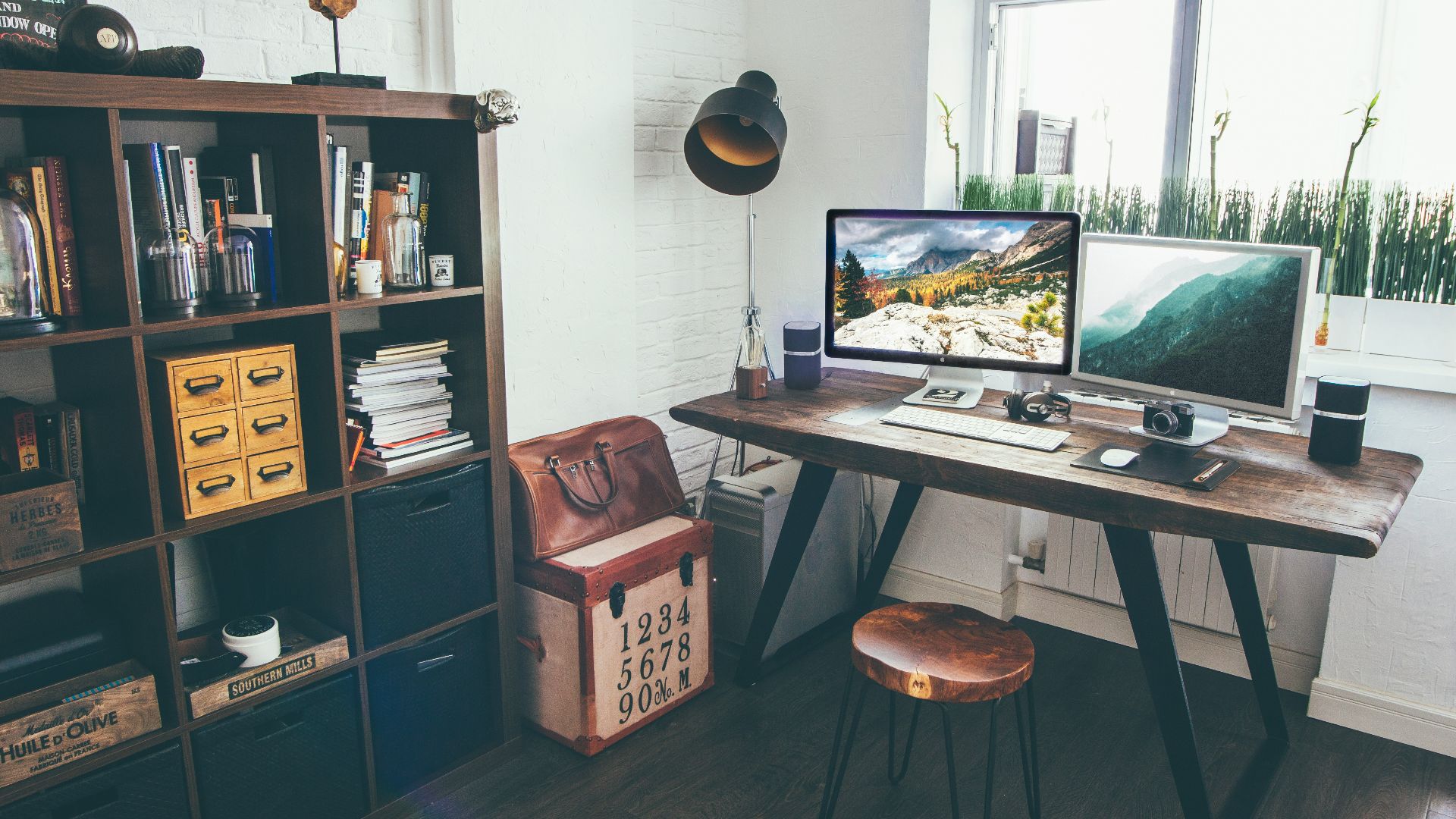 two flat screen monitor turned on near organizer rack inside the room