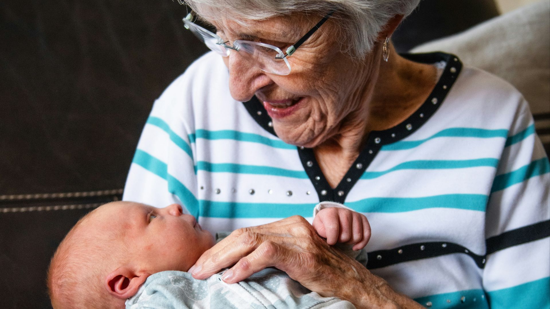 an older woman holding a baby