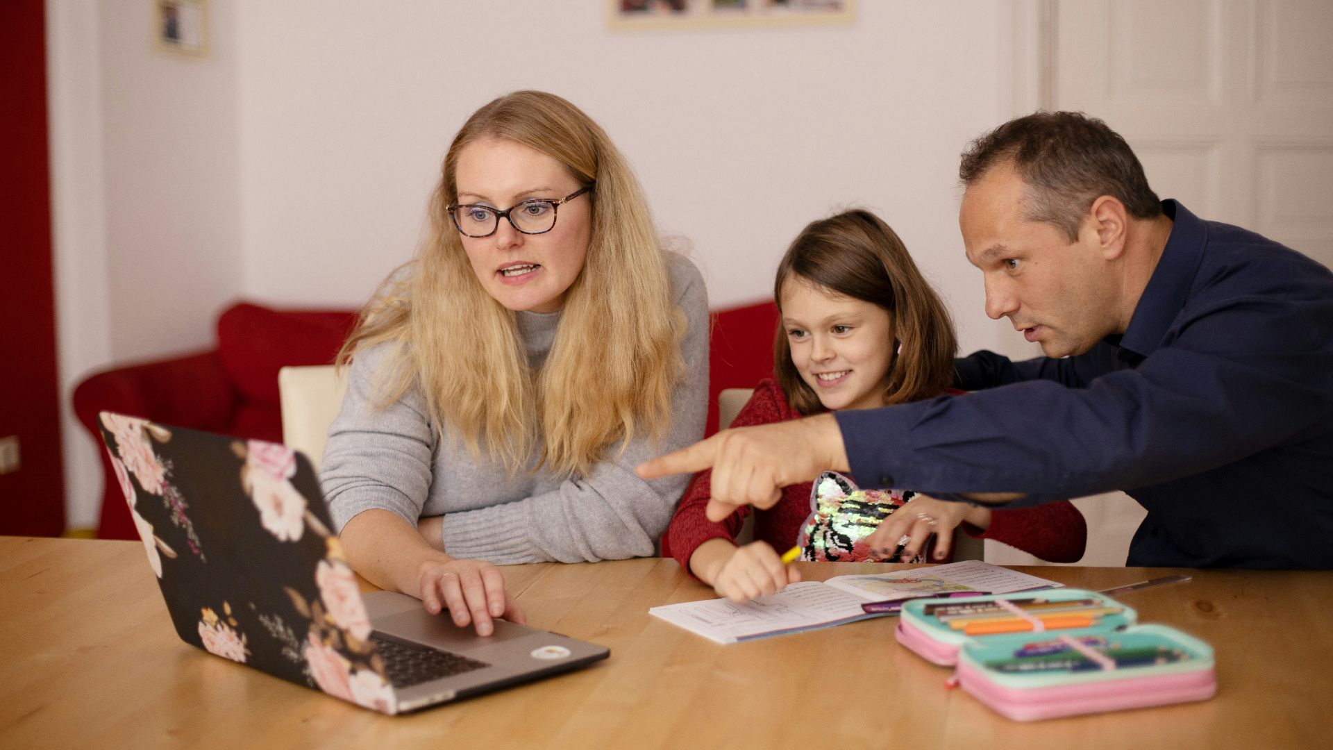 woman in gray long sleeve shirt sitting beside boy in blue sweater