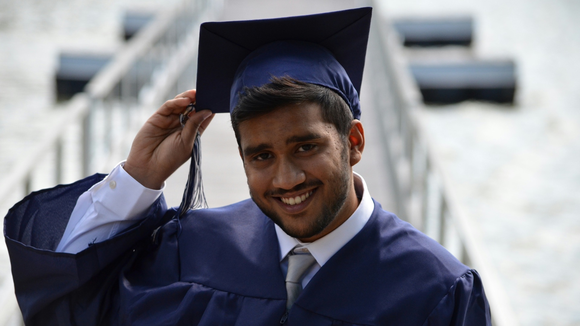 man holding his graduation cap