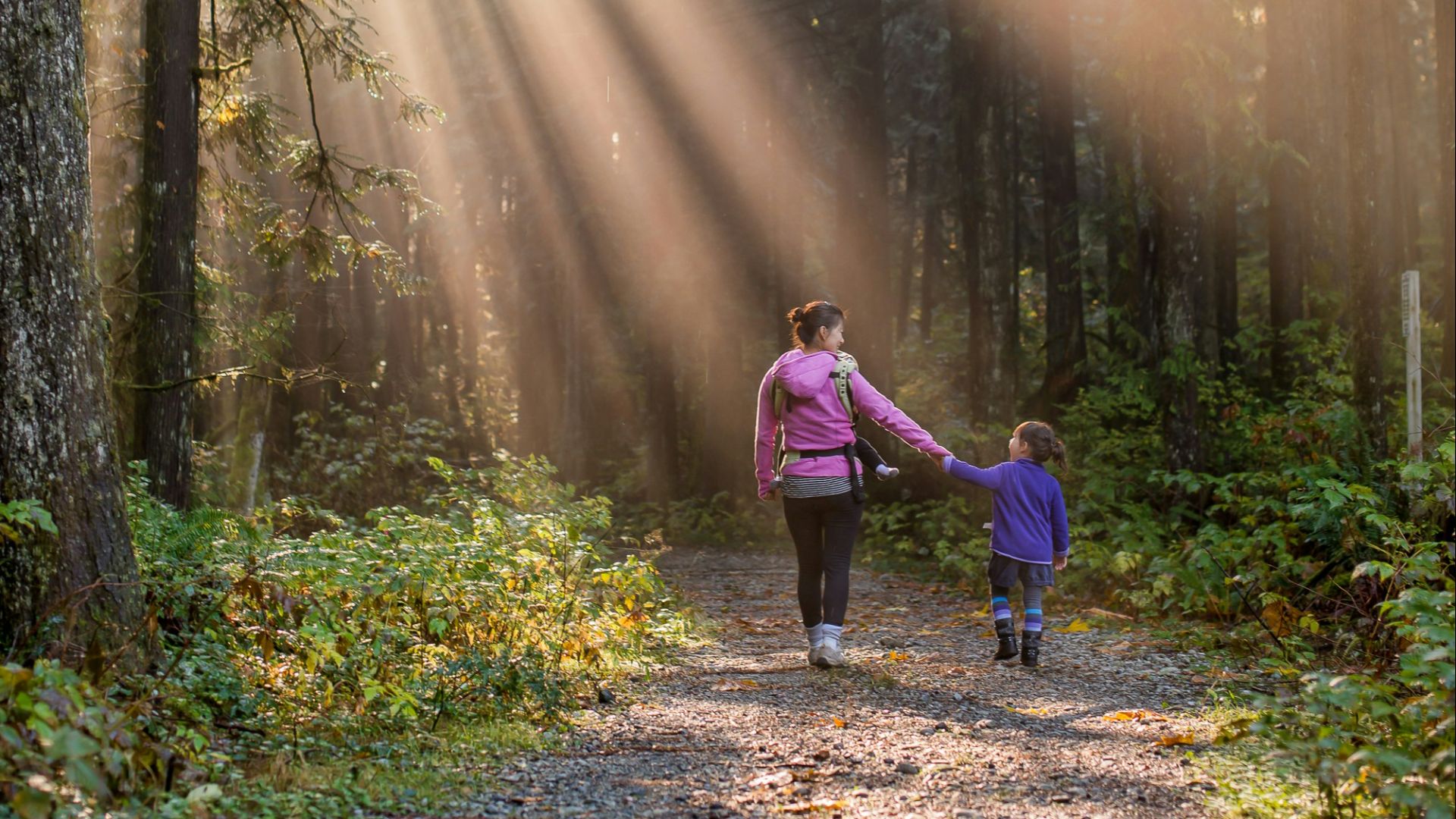 woman walking in forest with child