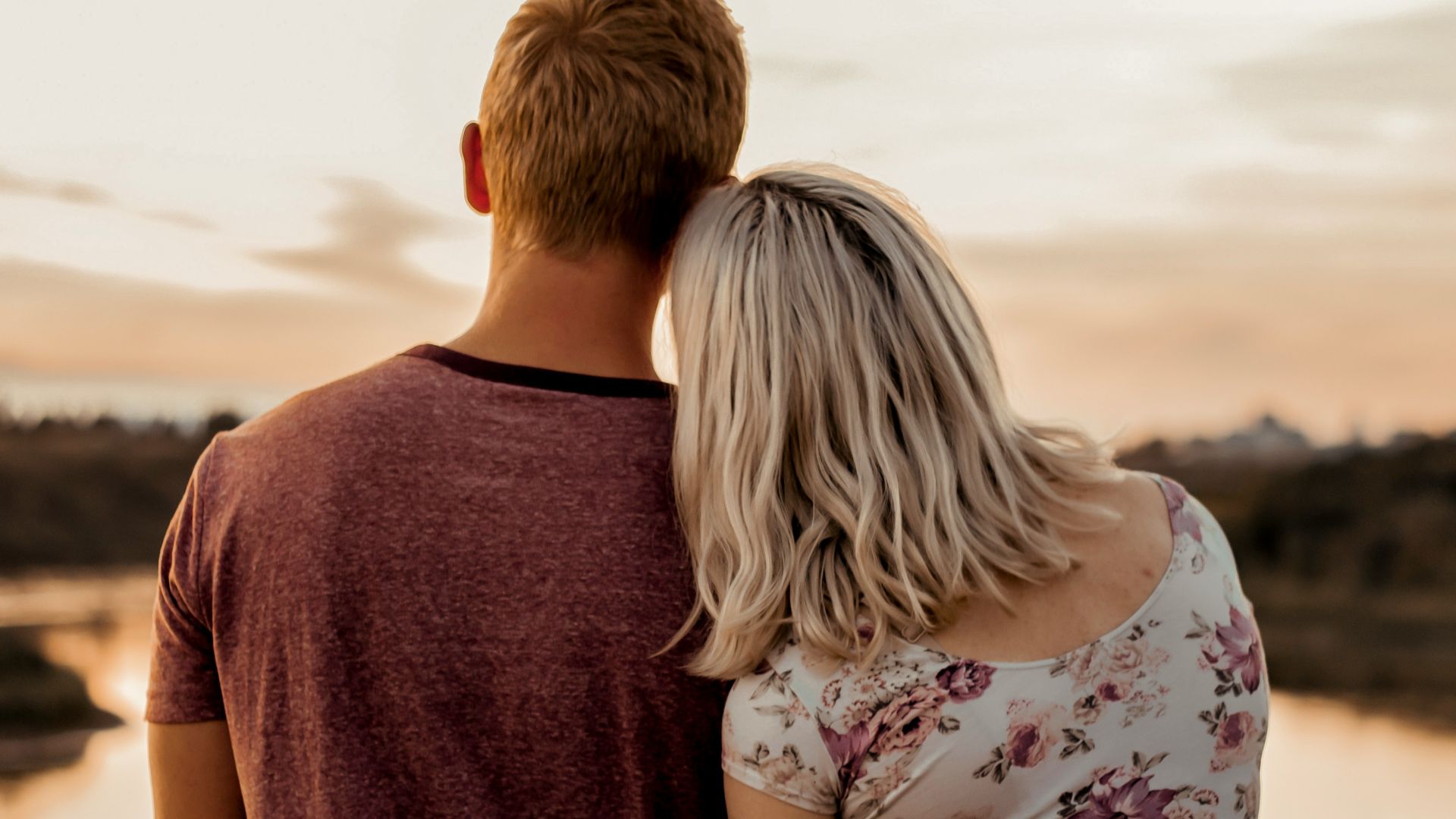 man and woman standing on brown field during daytime