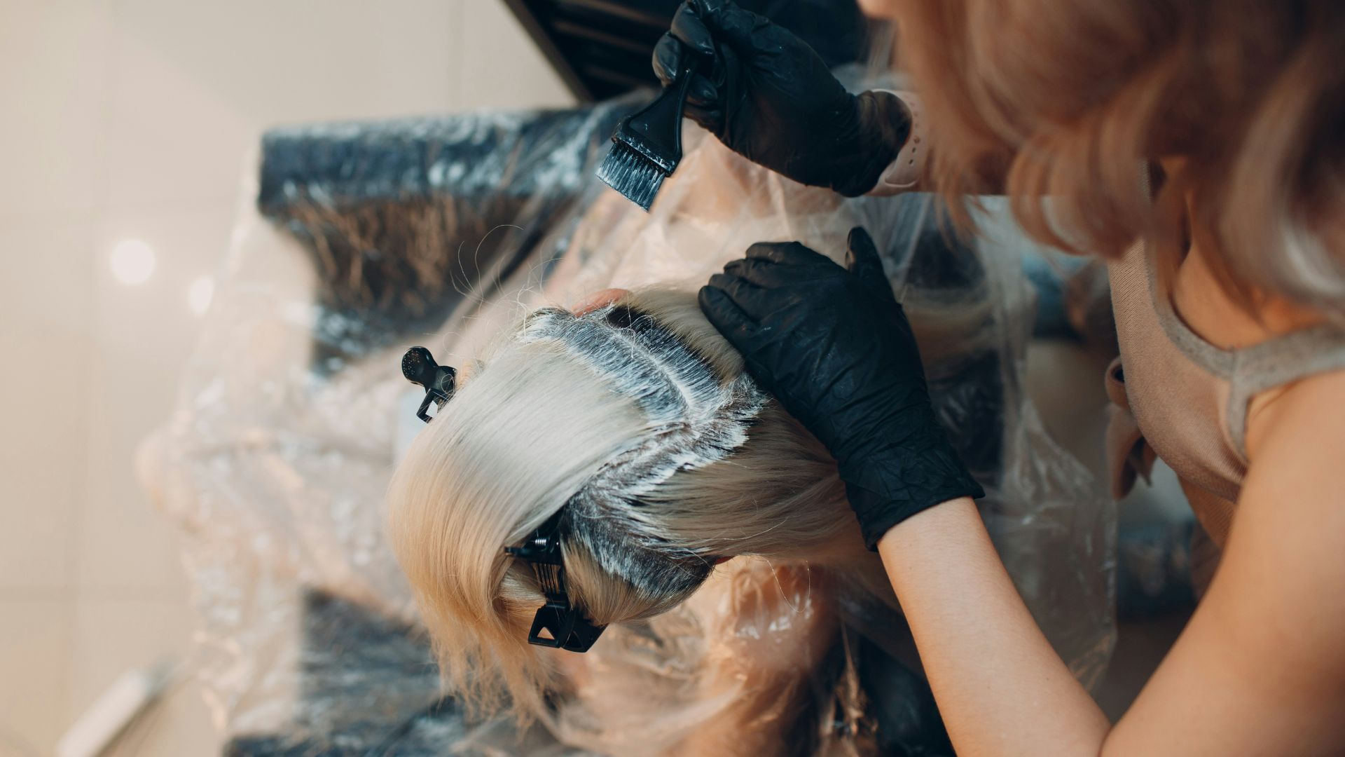 woman in black shirt lying on white textile