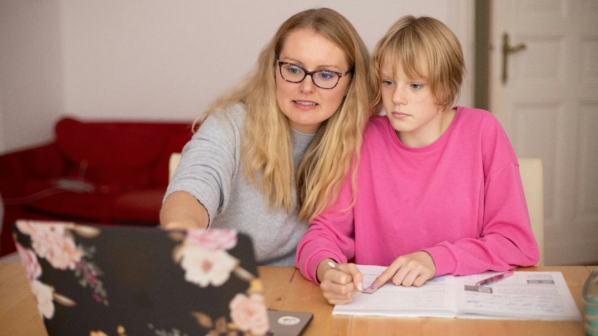 girl in pink sweater beside girl in gray sweater