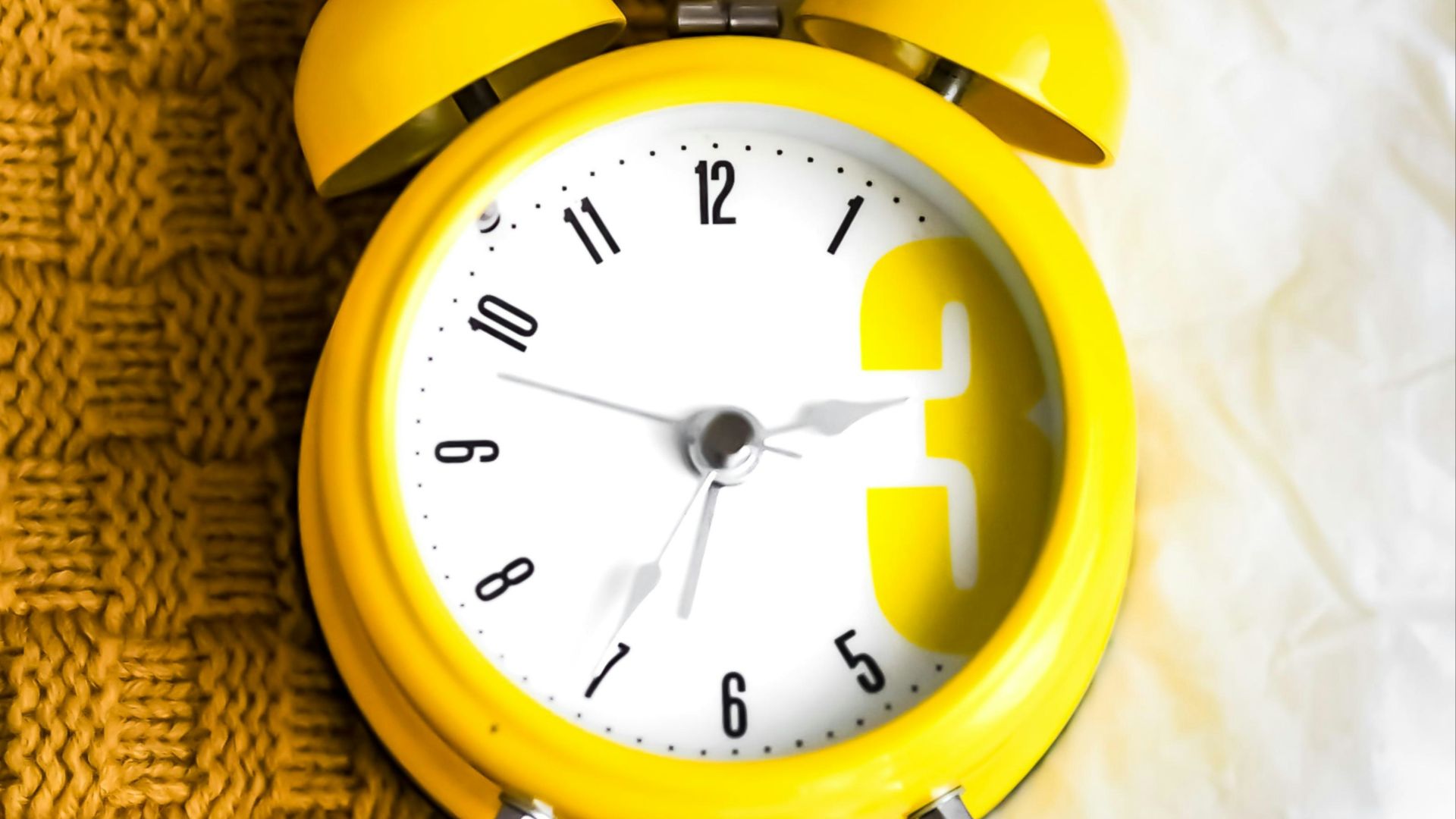 yellow and white alarm clock at 10 10