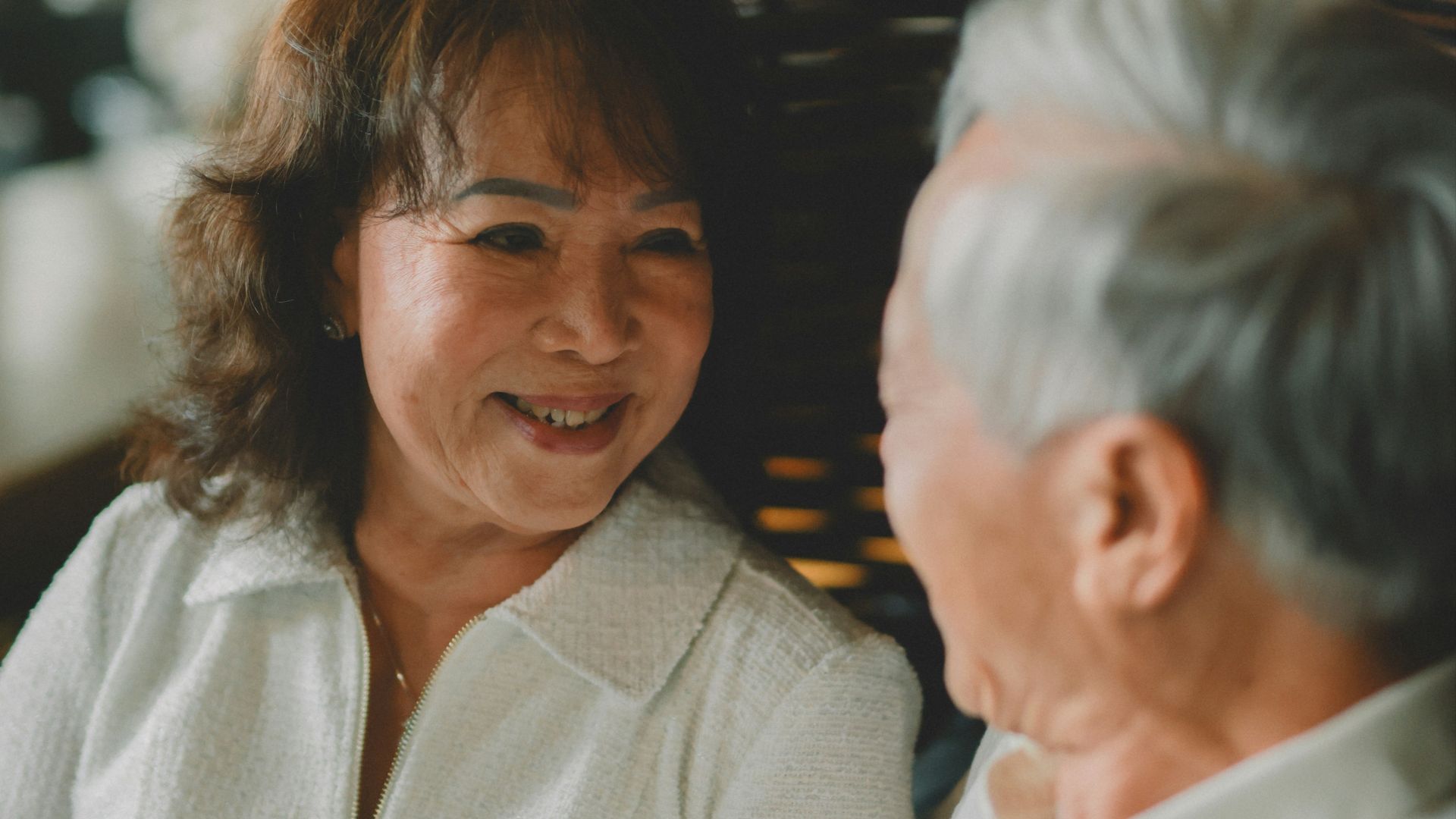 Elderly couple talking and smiling at each other