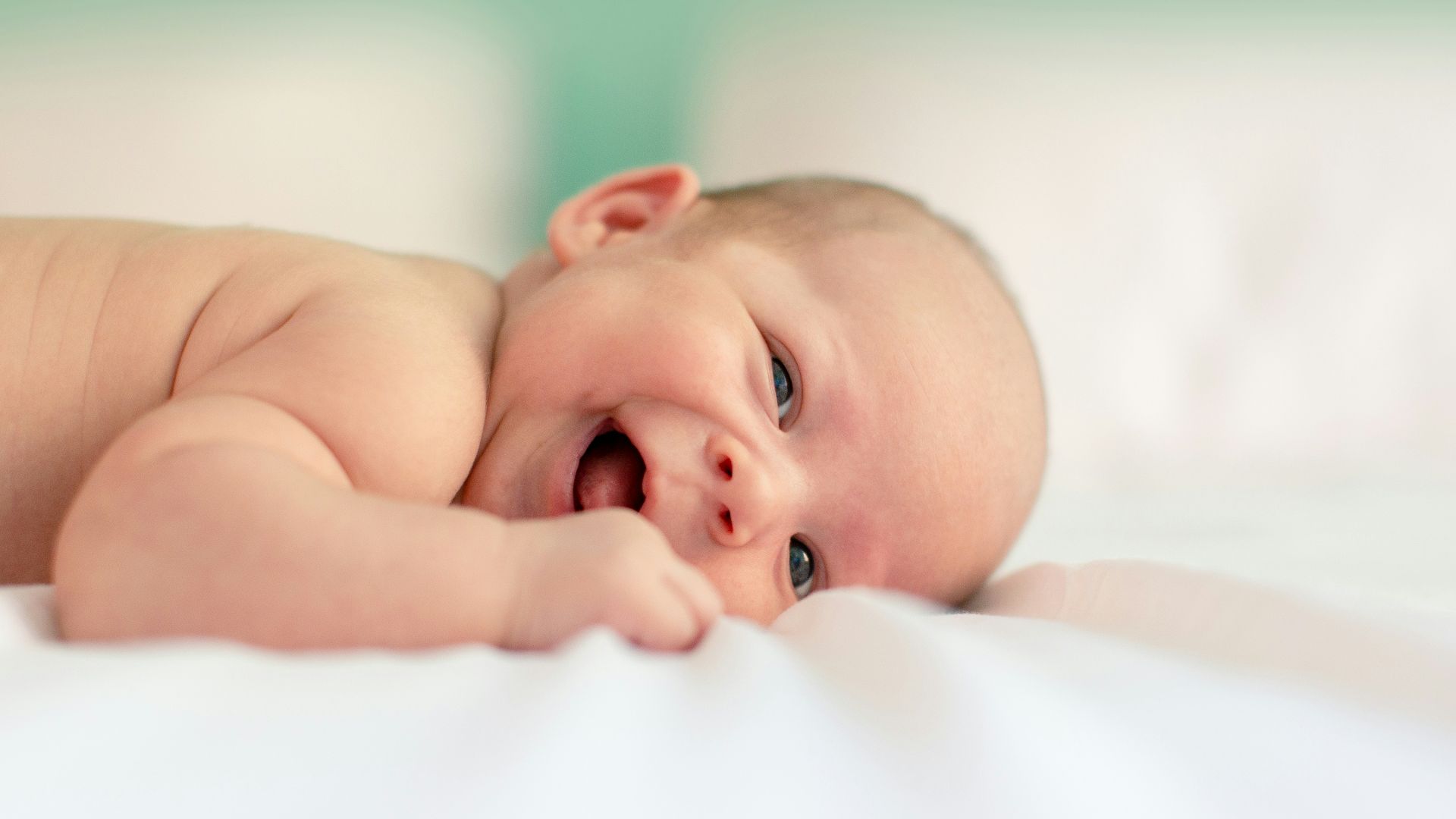 baby lying on fabric cloth