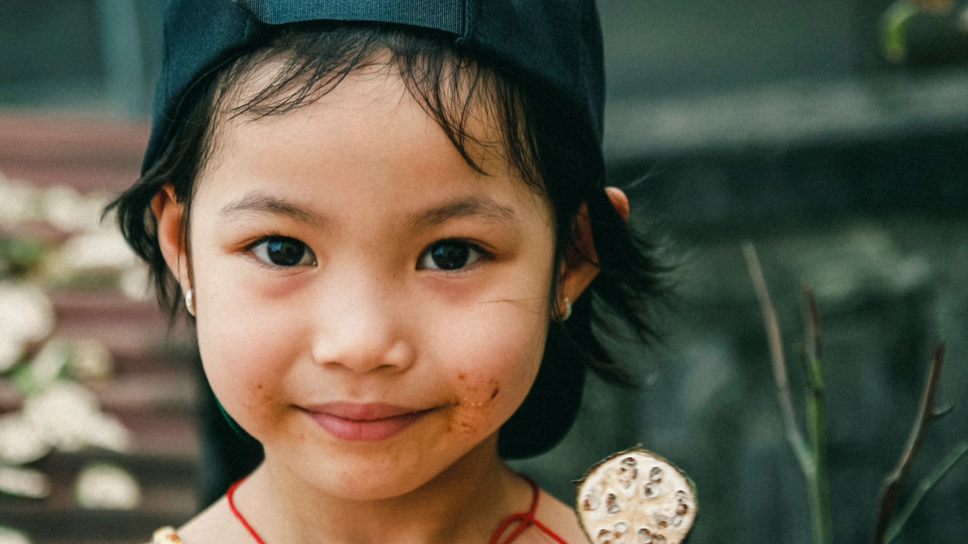 portrait photography of girl holding round coin