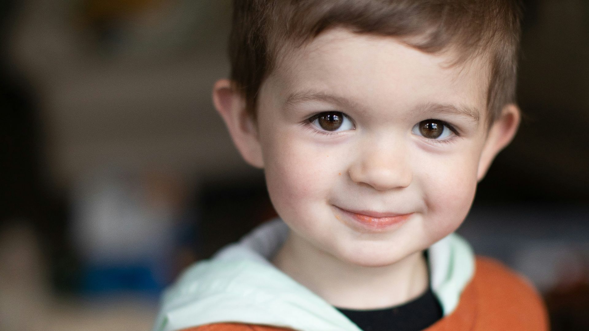 a little boy that is smiling for the camera