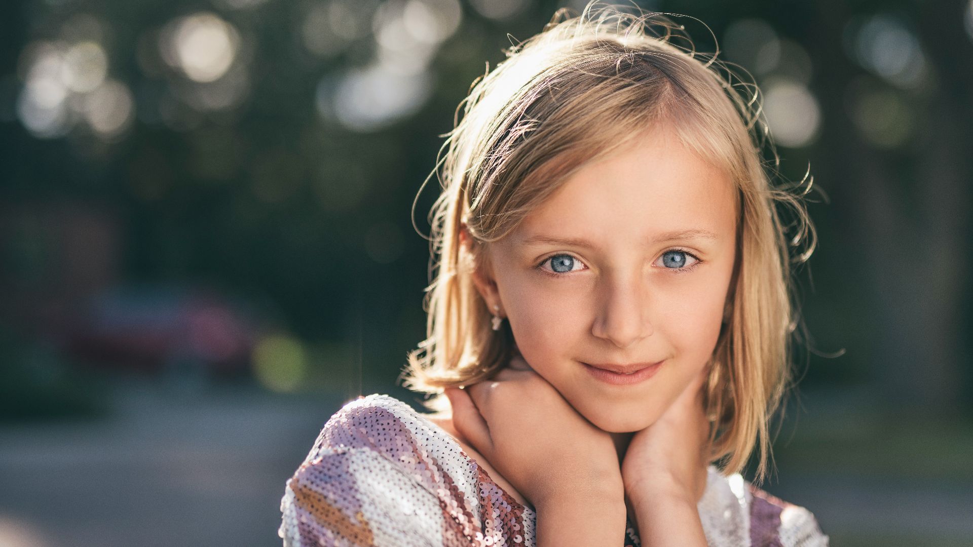 selective focus photography of girl in sequined white-and-pink stripe shirt