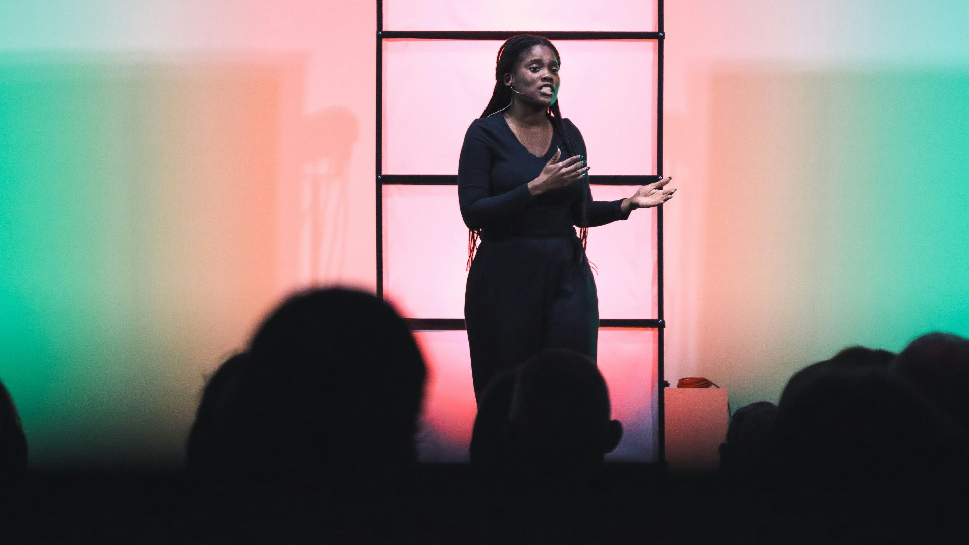 a woman standing on a stage with a microphone