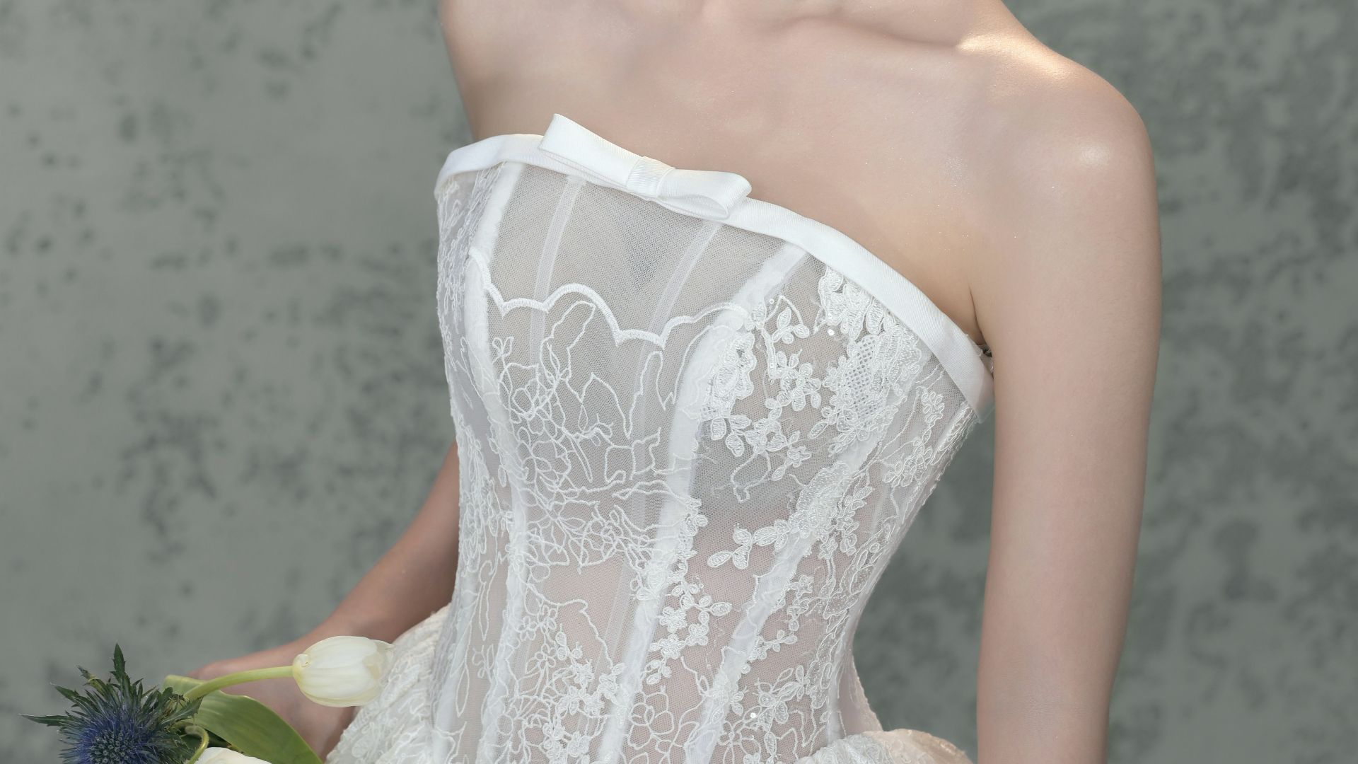 Bride in white lace dress holding a bouquet