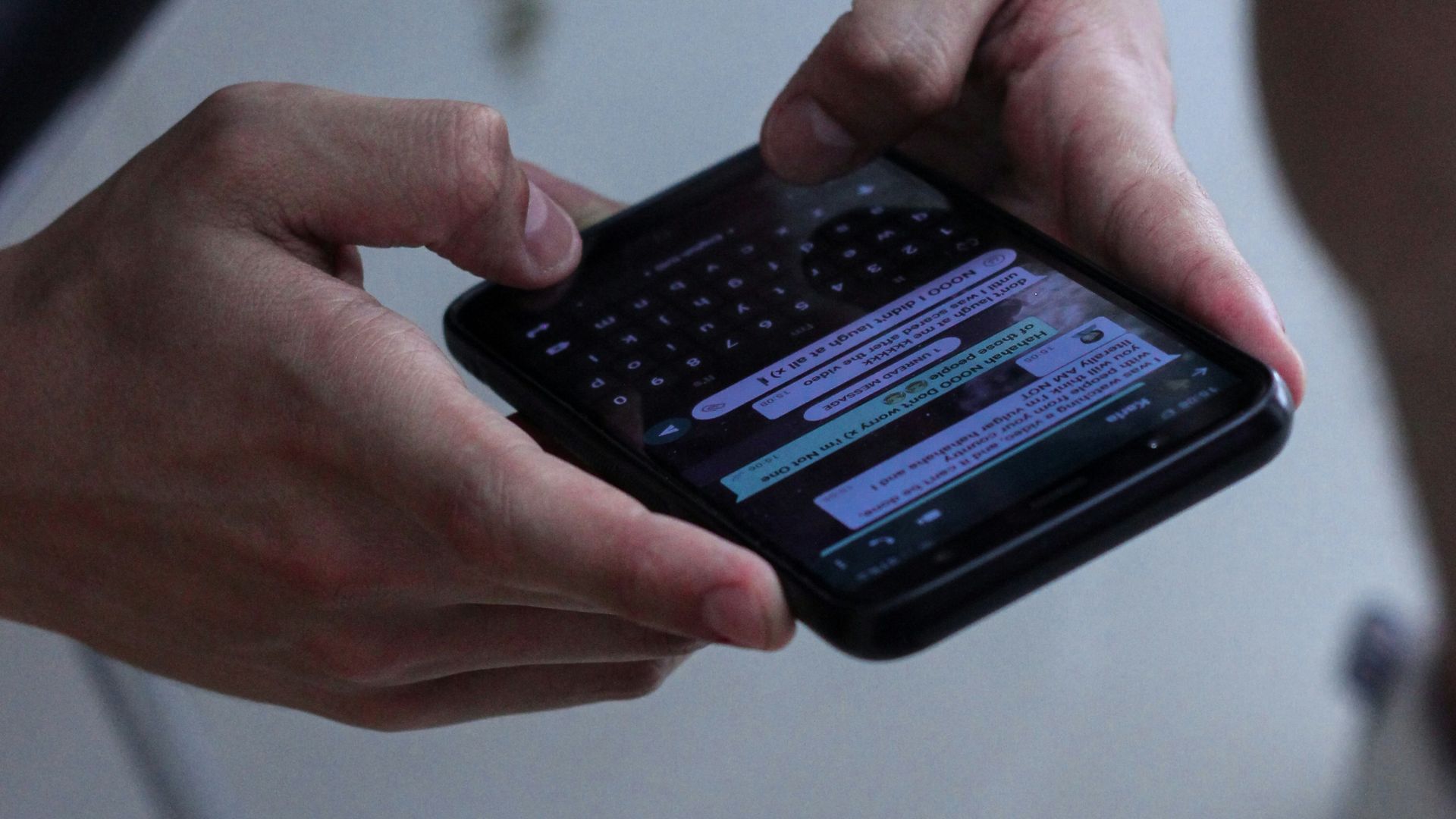 person holding black iphone 4